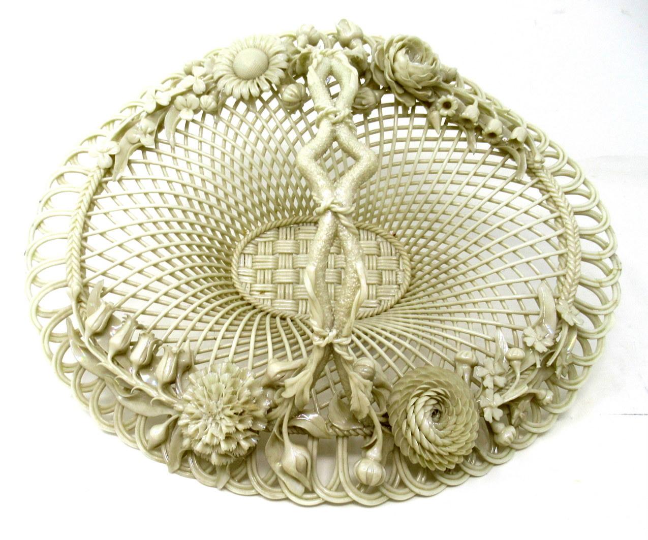 Stunning Example of an extremely rare Irish Belleek Porcelain Flower Encrusted Four Strand Basket of oval form. Nineteenth Century. 
This exceptional Belleek porcelain basket is an outstanding example of the delicate artistry for which this
