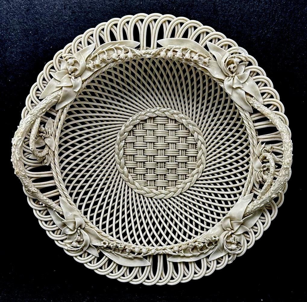 Stunning Example of an extremely rare Irish Belleek Porcelain Flower Encrusted Three Strand Basket of circular outline. Nineteenth Century. 

This exceptional Belleek porcelain basket is an outstanding example of the delicate artistry for which