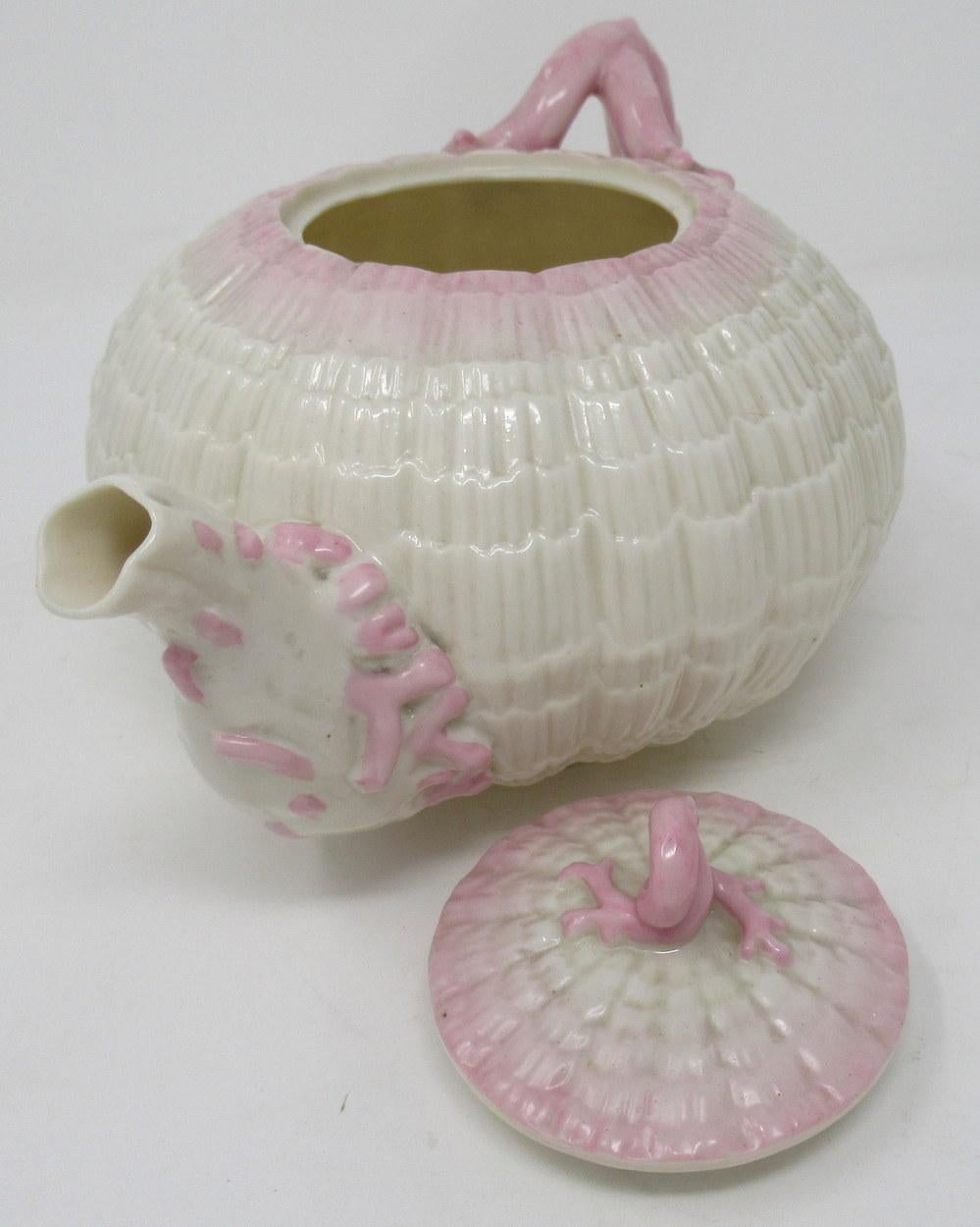 Early Irish Belleek Porcelain Tridanca tea pot with textured body and stylish almond pink wash detail. Complete with original firm fitting cover with a finial, together with matching cream jug and sugar bowl. 

First period black mark for