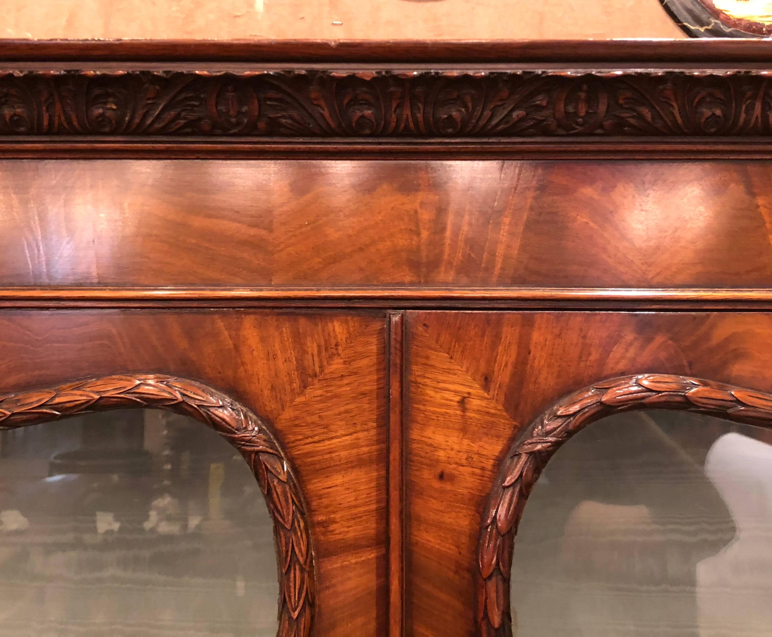 This handsome display cabinet commands your attention with its beautiful carving and fine walnut color.