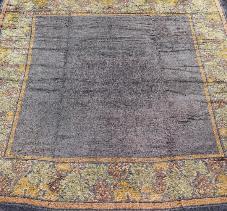 Antique Irish Donegal Carpet in solid Purple Background and Floral