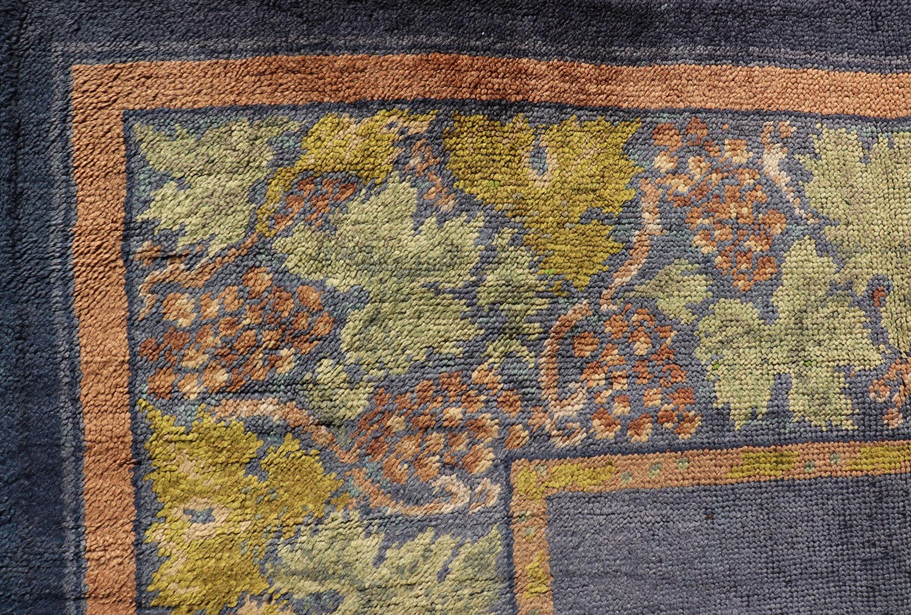 Antique Irish Donegal Carpet On A Solid Purple Background and Floral Border In Good Condition For Sale In Atlanta, GA