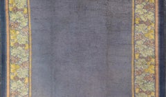 Antique Irish Donegal Carpet On A Solid Purple Background and Floral Border