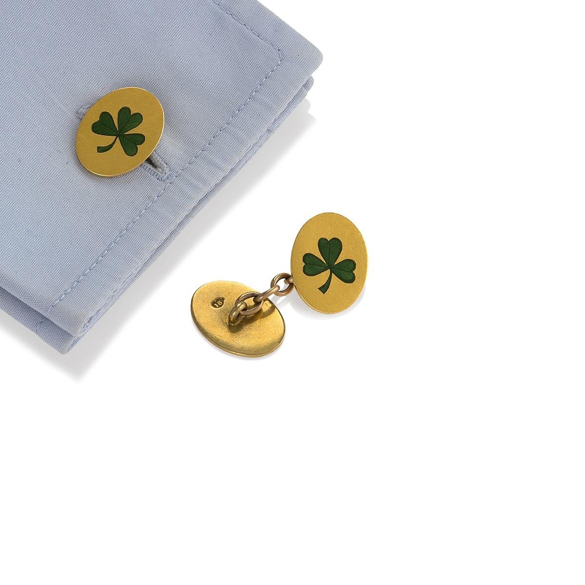 A pair of Irish Antique 18 karat gold and enamel shamrock cuff links.  The double-sided cuff links have detailed enamel depicting shamrocks on the front. The back oval is not enameled. Circa 1900's.

Signed, 