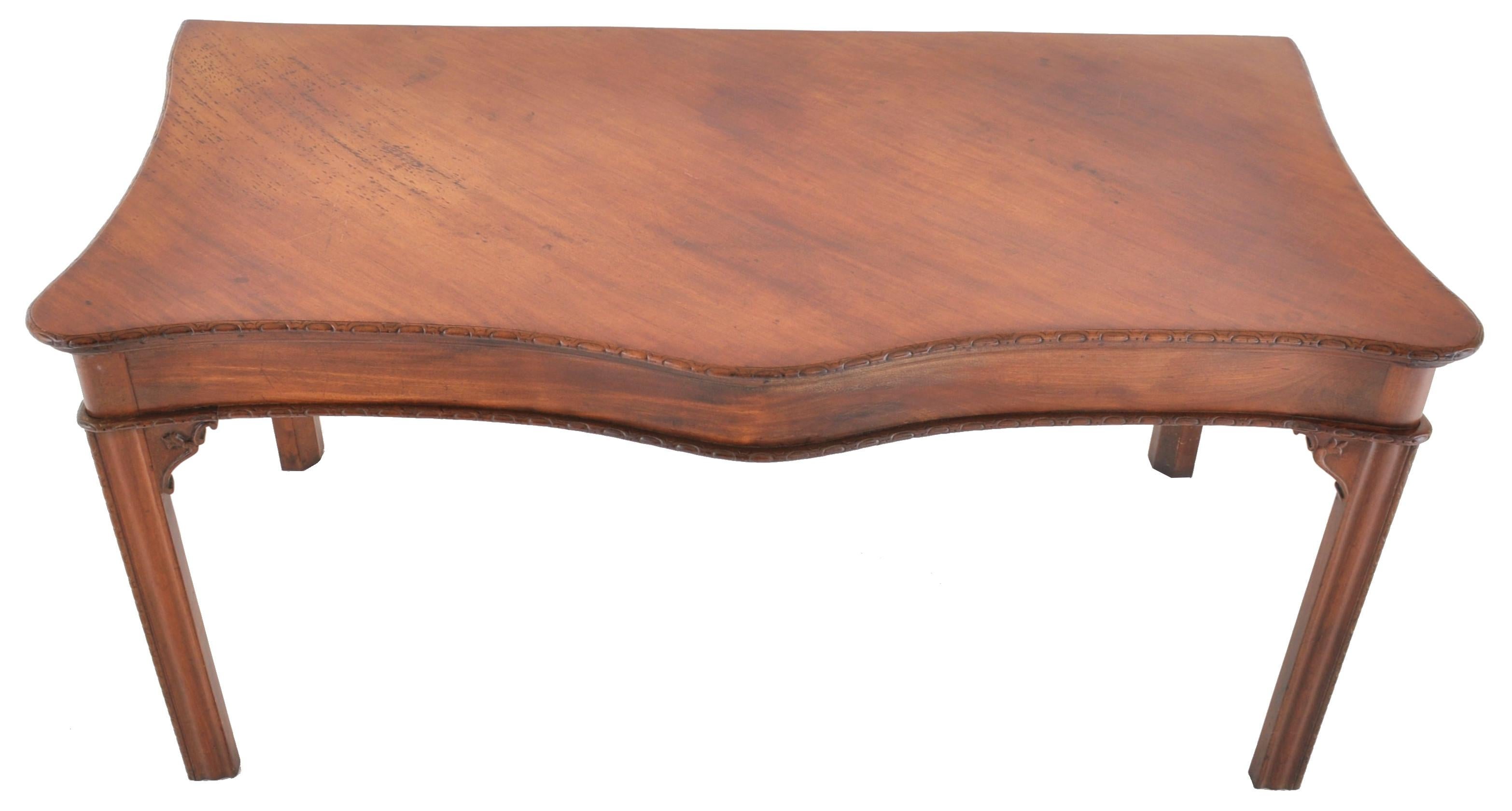 An important antique Irish George III Chippendale mahogany serving table/sideboard, circa 1770. The table made from the finest Cuban mahogany, having a serpentine shaped front with a gadrooned edge, the legs having carved Chinese style brackets and