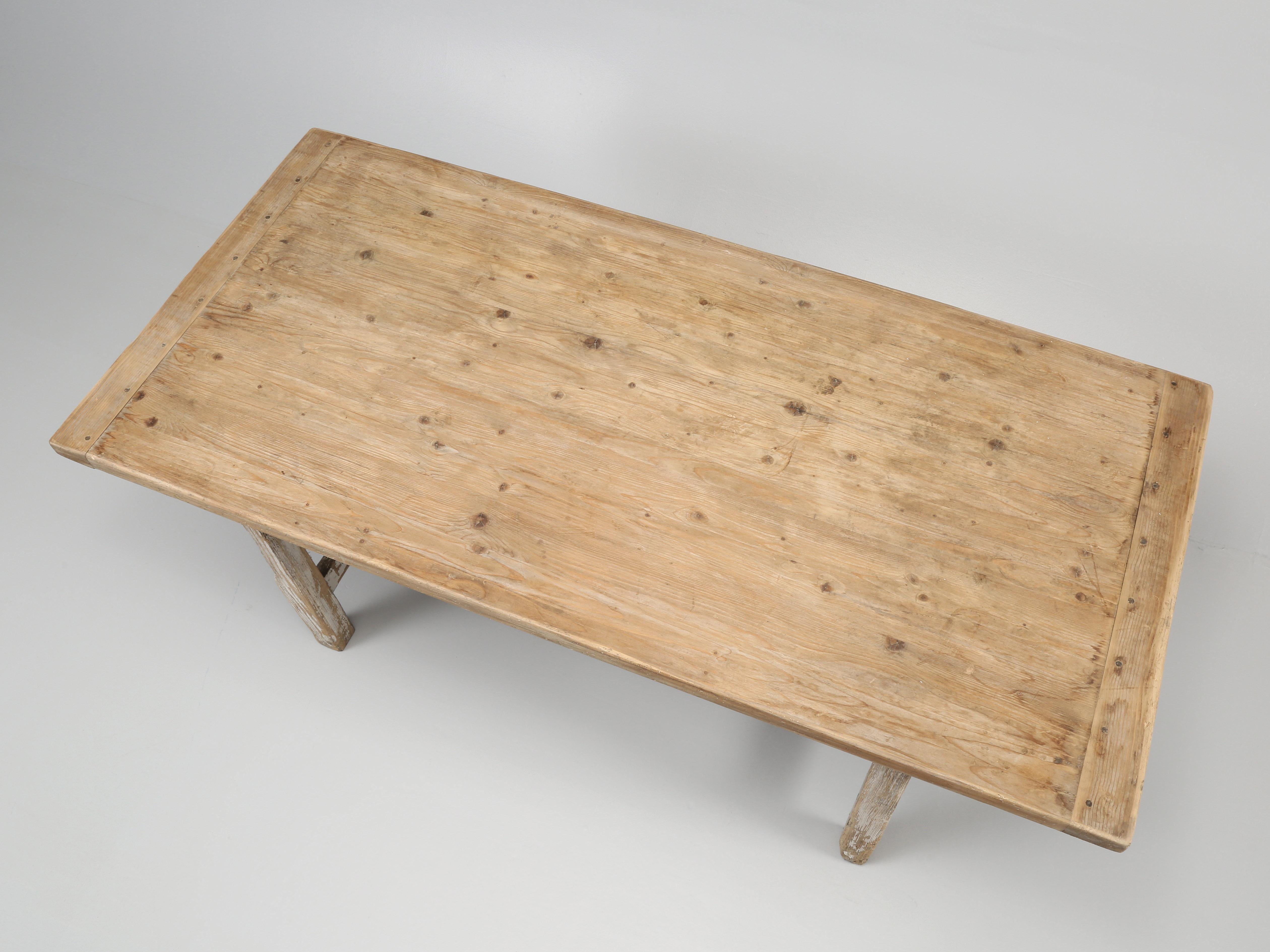 Antique Irish kitchen table or dining room table in its original unrestored state. Described by our Irish antique pine expert as; “19th C. painted pine kitchen table on square legs and double stretcher”. Man of few words, however it does accurately