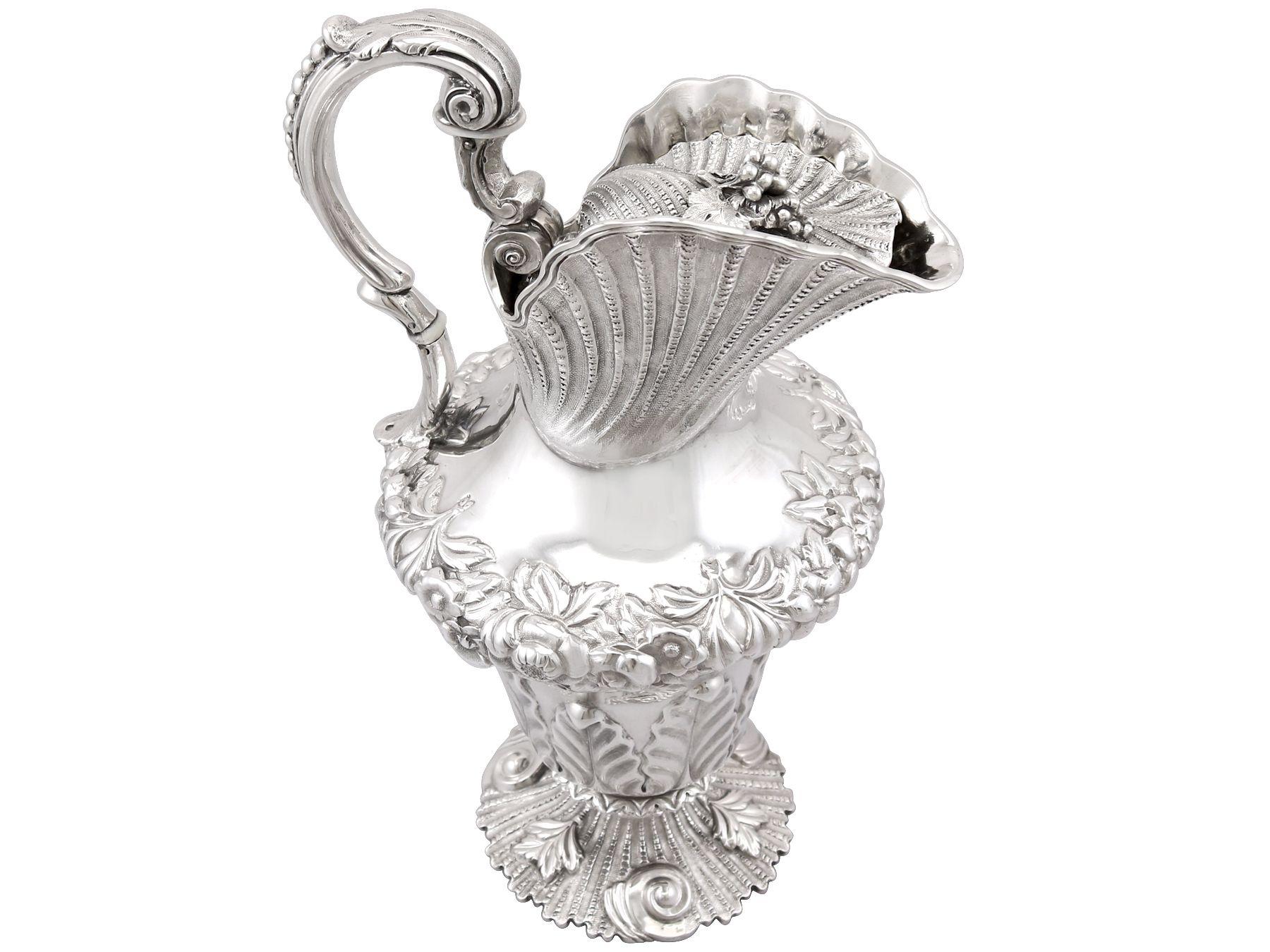 A magnificent, fine and impressive, large antique William IV Irish sterling silver water jug; part of our antique dining silverware collection.

This magnificent and large sterling silver water jug has an inverted baluster, shell shaped form onto