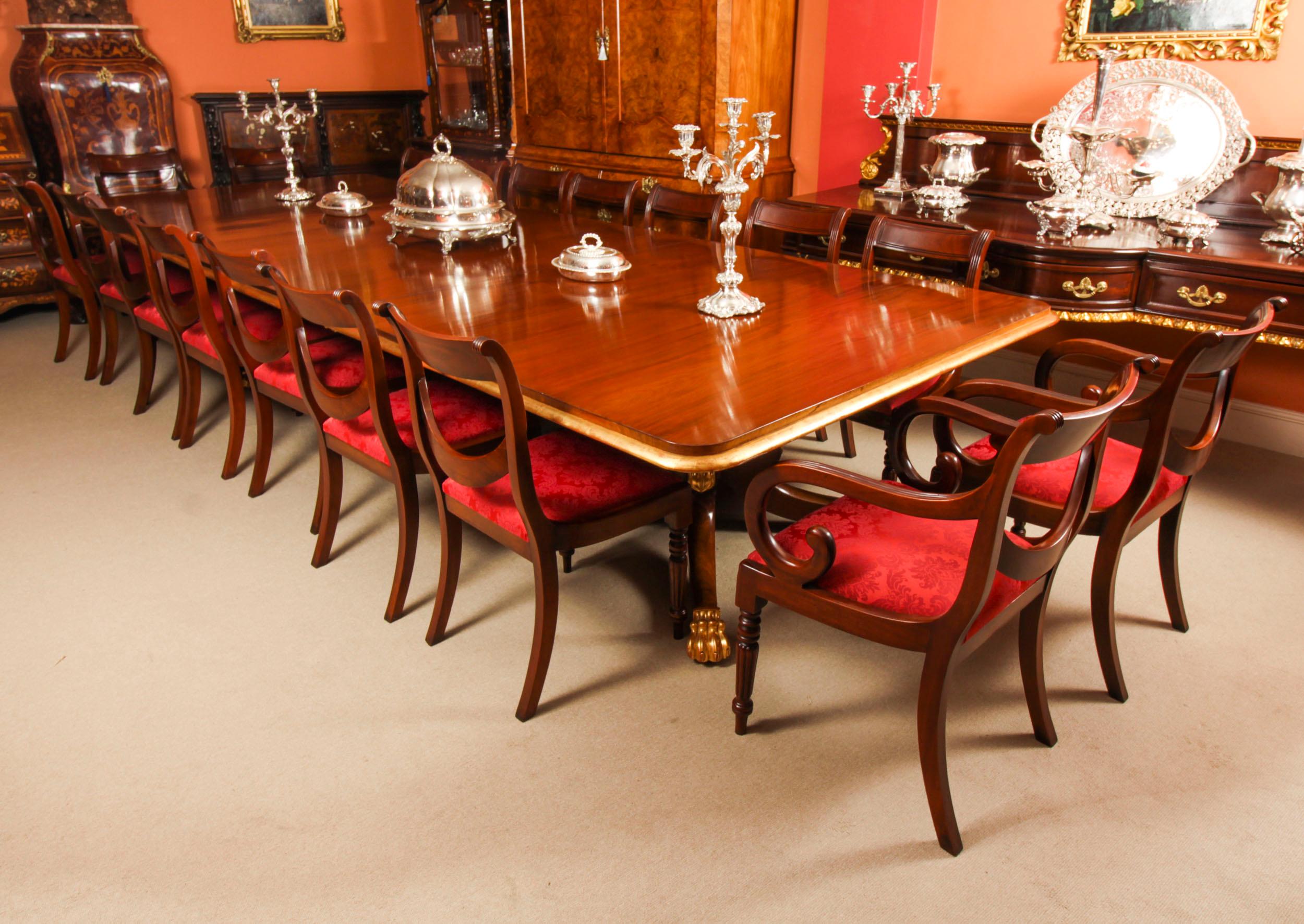 This is an elegant antique Irish Regency Period mahogany & parcel-gilt dining table, Circa 1820 in date with a set of eighteen Regency Revival swag back dining chairs.

The table top is of beautiful flame mahogany and there is no mistaking the