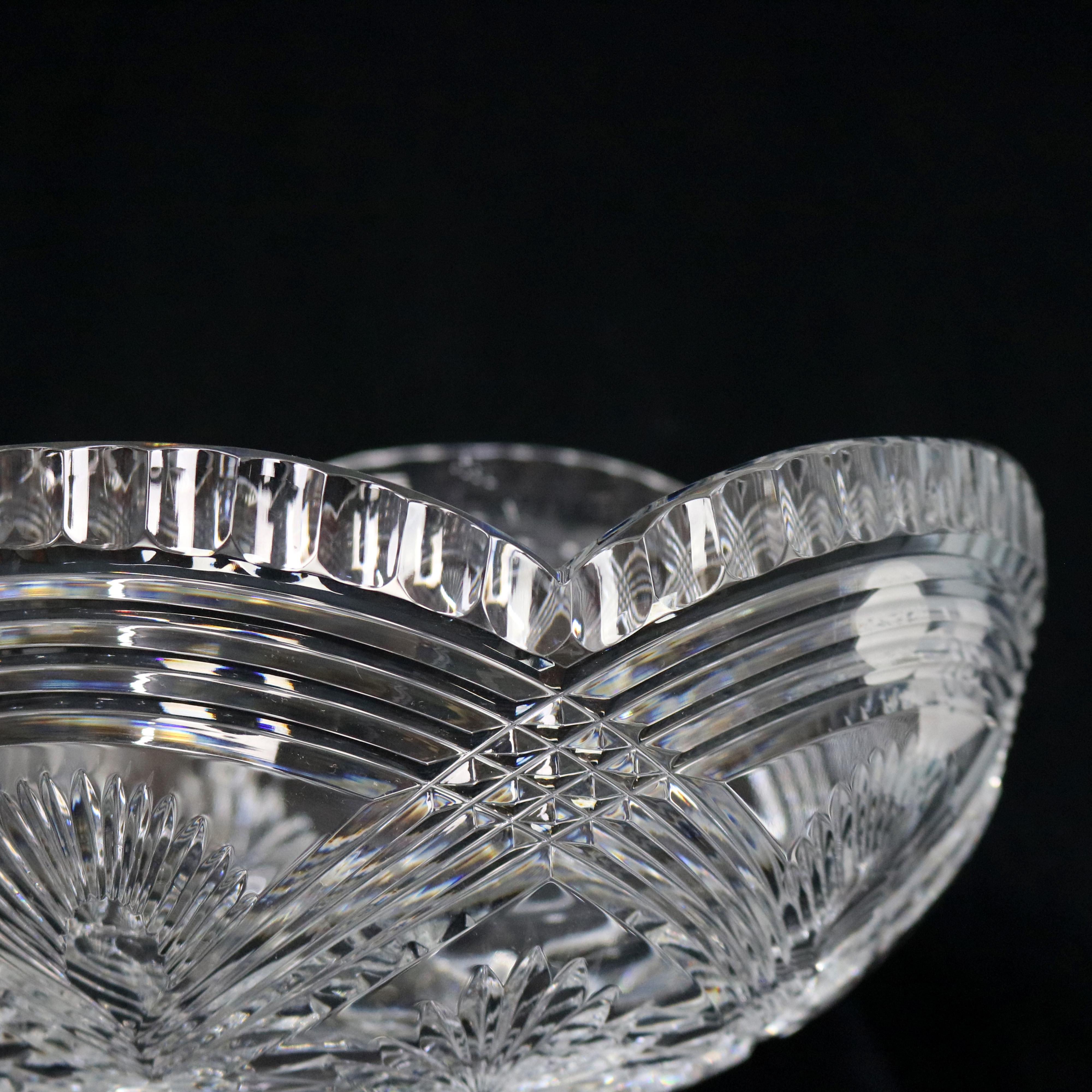 An antique Irish crystal center fruit bowl by Waterford offers curt crystal bowl with scalloped rim and raised on shaped pedestal, signed, c1930

Measures: 8.75