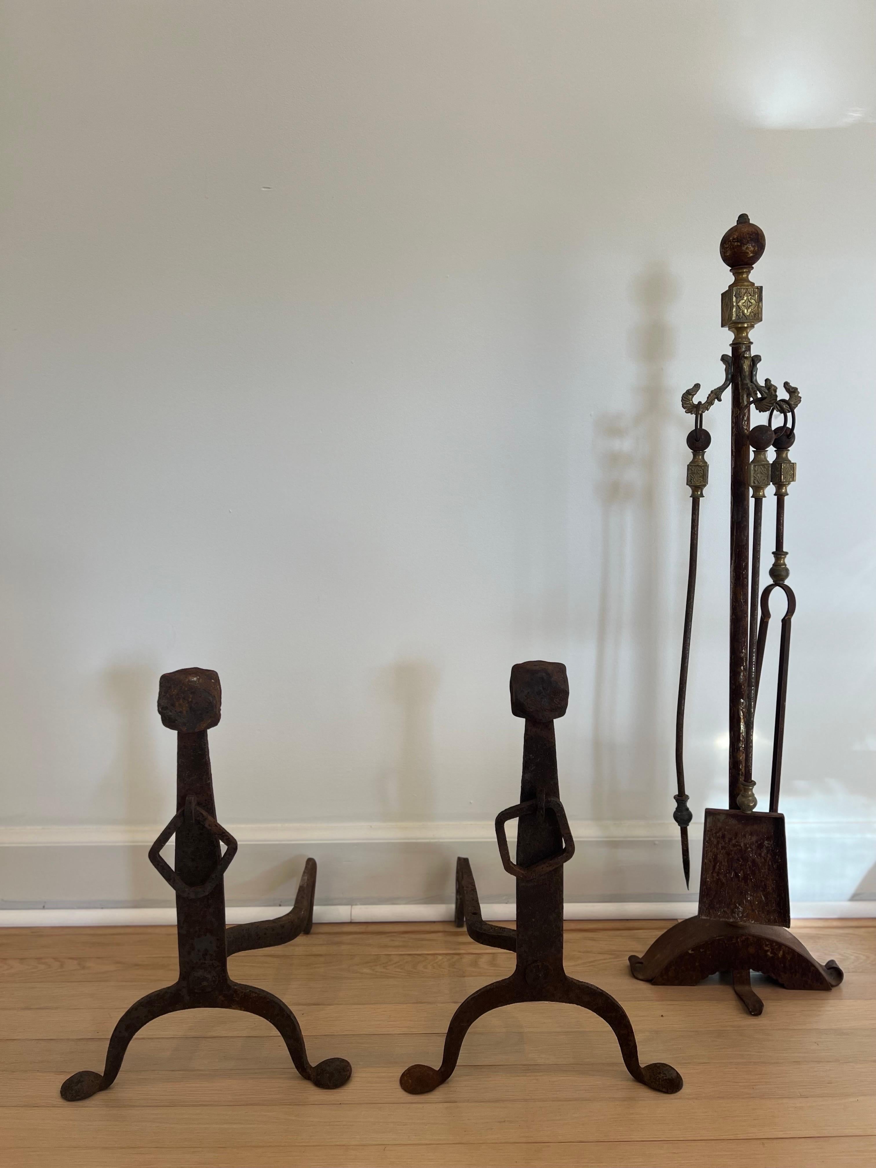 Exceptional and unique set of fireplace tools including andirons. 
Iron shows years of patina adding to the aged beauty of this set. 

Acquired on a trip to Europe from old estate.