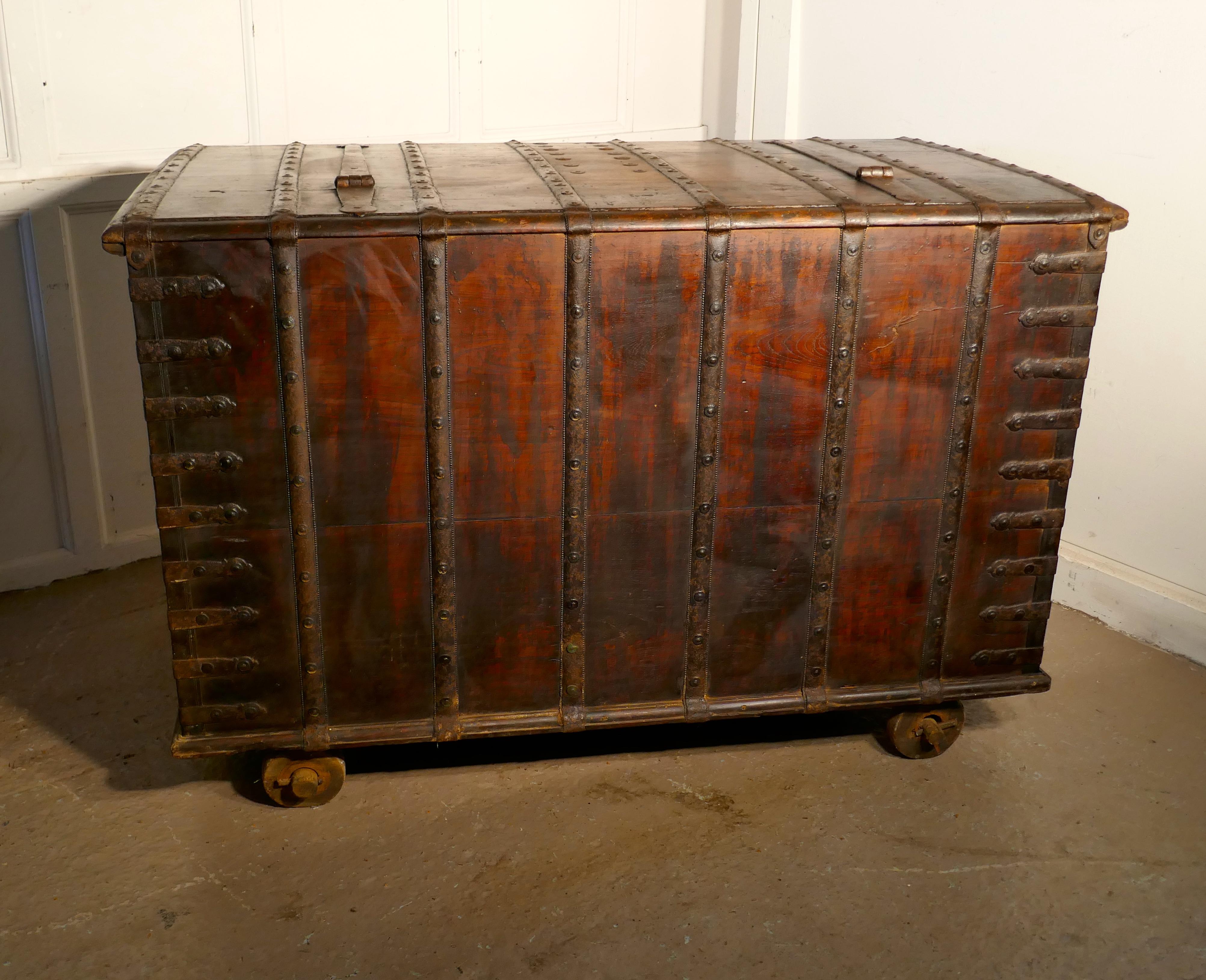 Antique iron bound merchants chest with hidden compartments. 

The chest is very heavy, it has a great deal of thick iron banding and brass and iron studs both for strength and decoration. 
Chests like these were made for merchants to transport