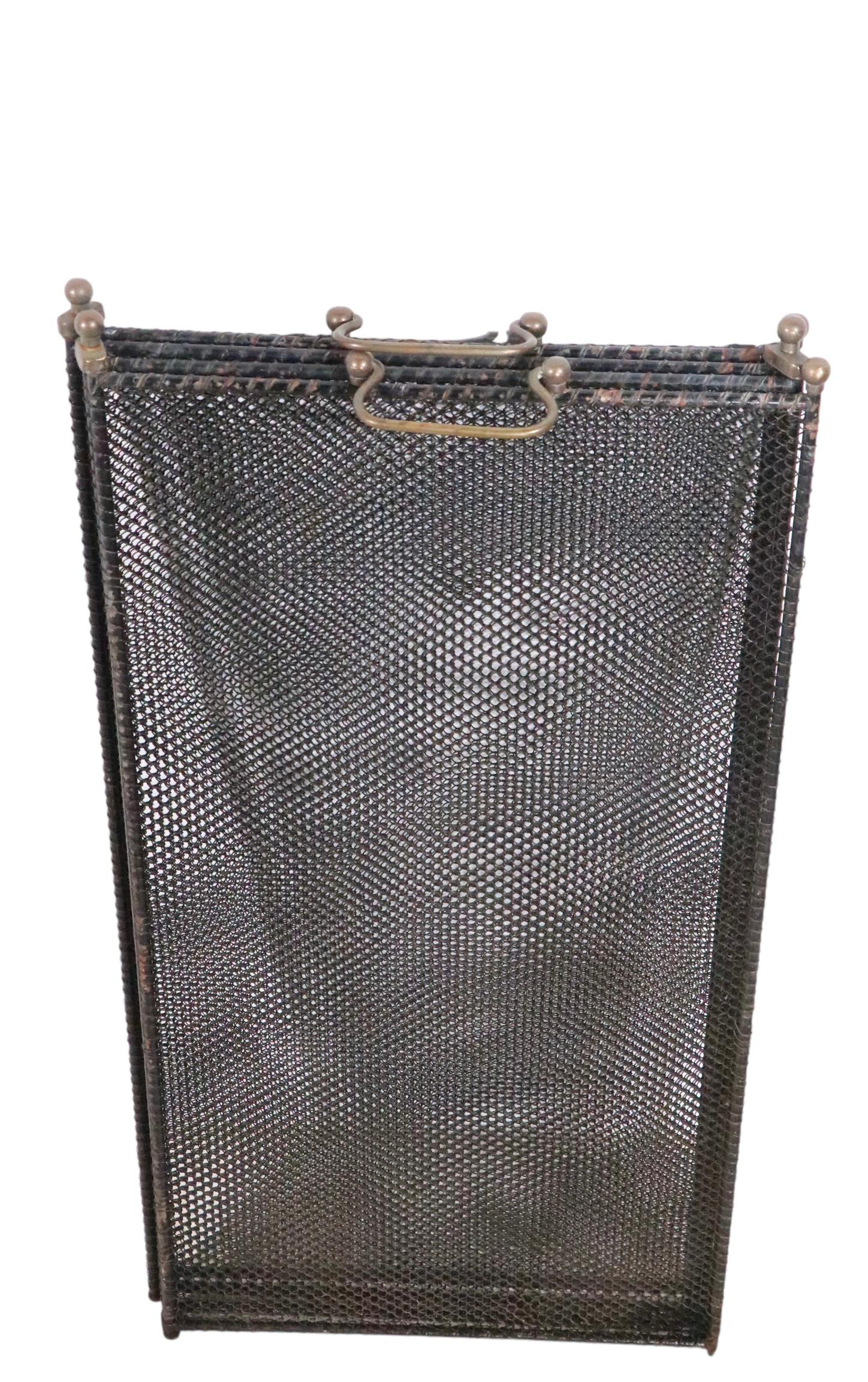 Classic  folding fireplace screen, having four rectangular panels, each 12 W x 20 H inches, ( 25 H inch H including the brass handle ). The total W of the screen is adjustable as it is flexible, up to approx. 49 in W. This spark guard  is in very