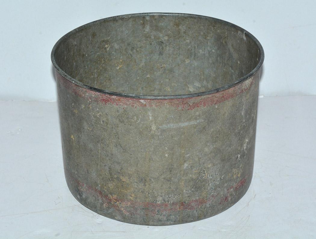 The rustic antique iron bucket is finished with a curled rim. The bottom is stamped with 