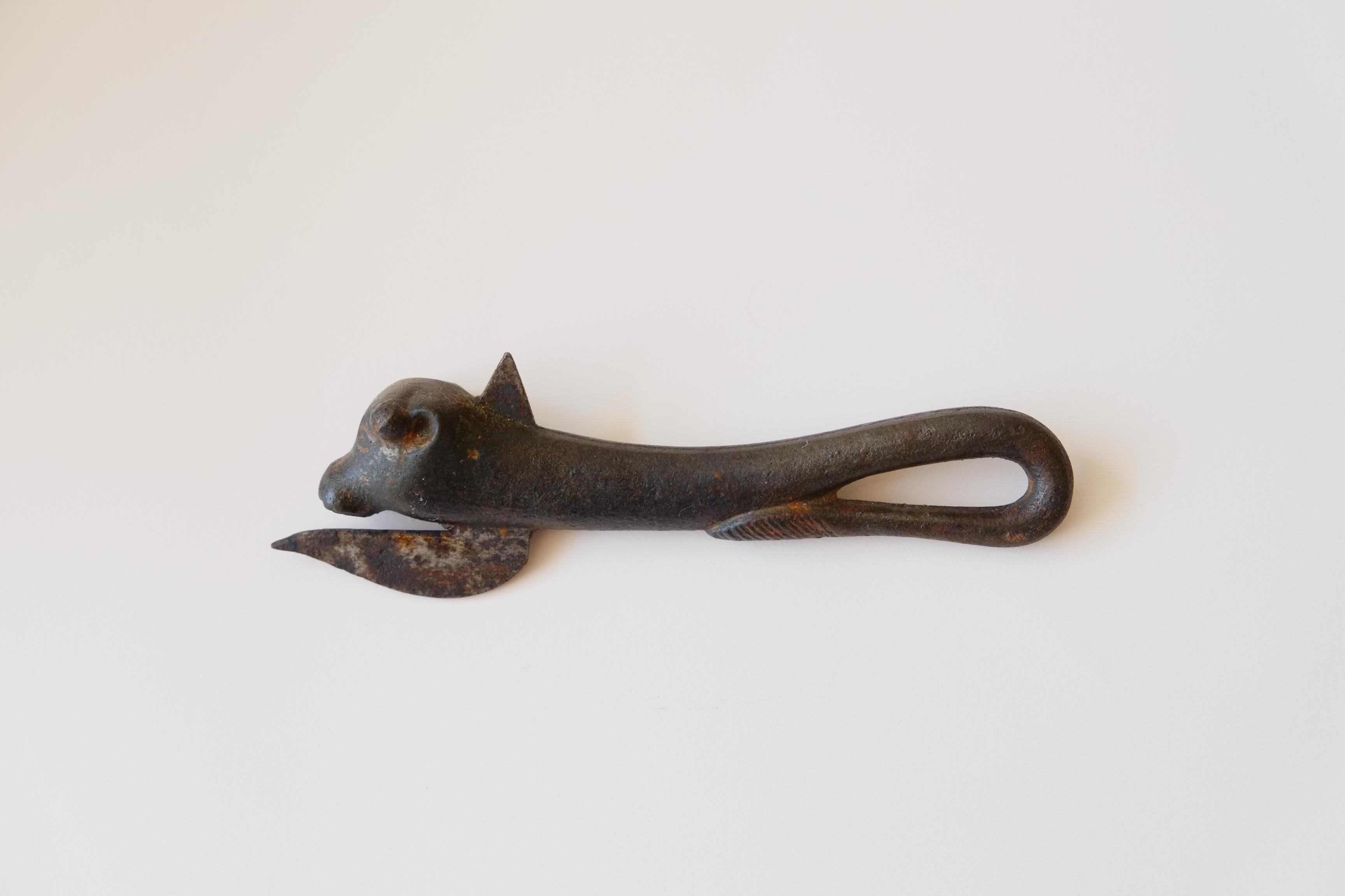A beautiful cast iron antique bottle or can opener in the form of a bull. From the early 20th century - the stylish abstract bull figure makes for a timeless novelty piece. The perfect addition to any bar. 

measures approximately 16 cm high x 5 cm