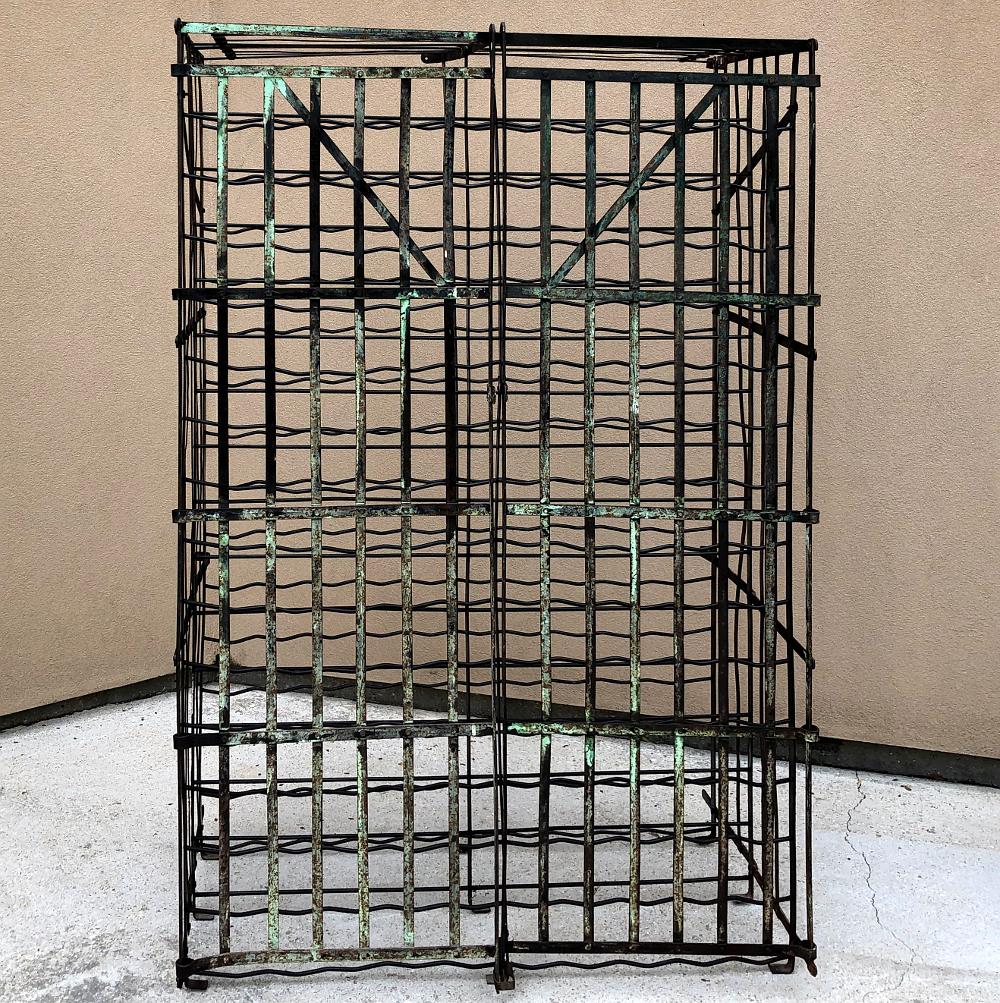 Antique Iron Cage Wine Bottle Rack is the perfect choice for a wine connoisseur or a restaurant owner! Designed to hold up to 150 bottles, it was constructed of steel and has seen at least two painted finishes in its lifetime so far. The front gates
