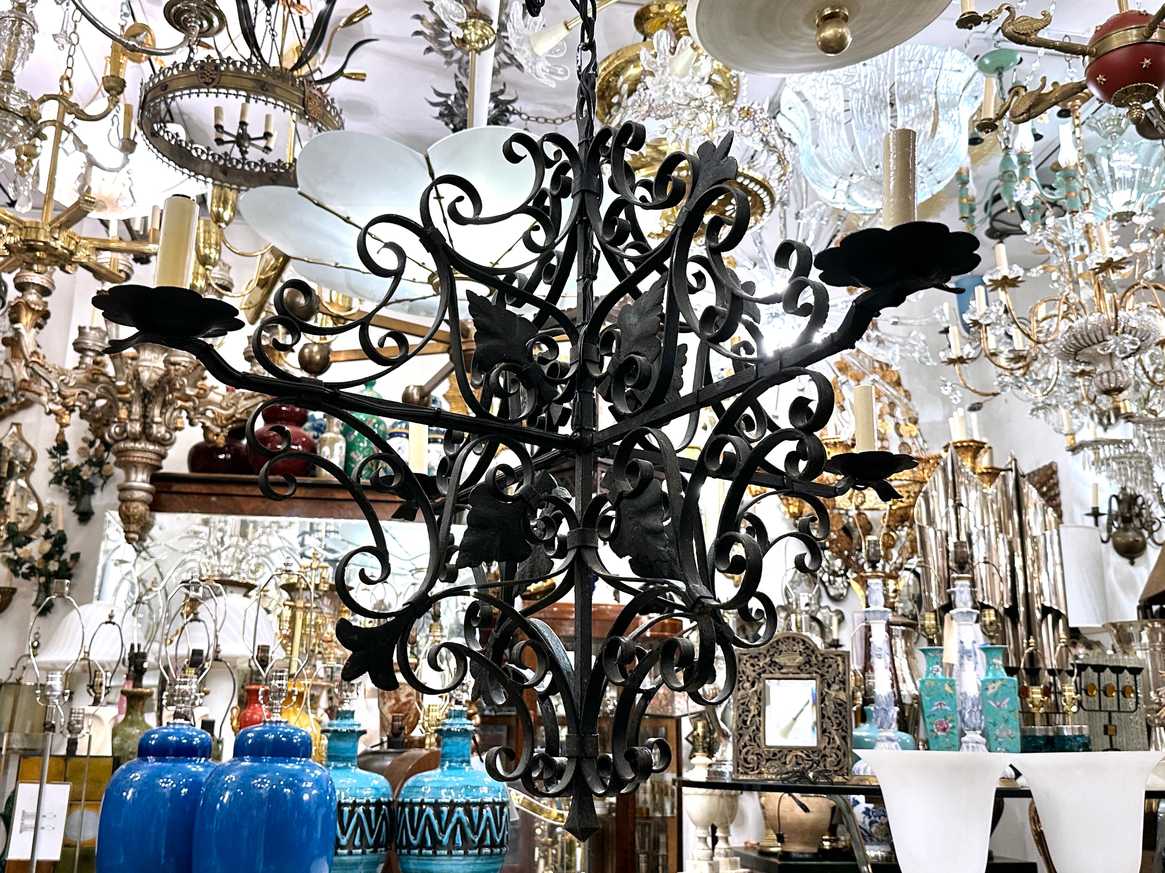 A circa 1920's French four-sided iron chandelier.

Measurements:
Minimum drop: 34