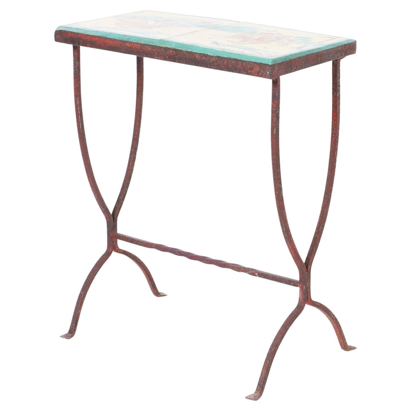 Standout antique table or stand having two polo themed arts and crafts style glazed earthenware tiles over an elegant iron base now oxidized to perfection.