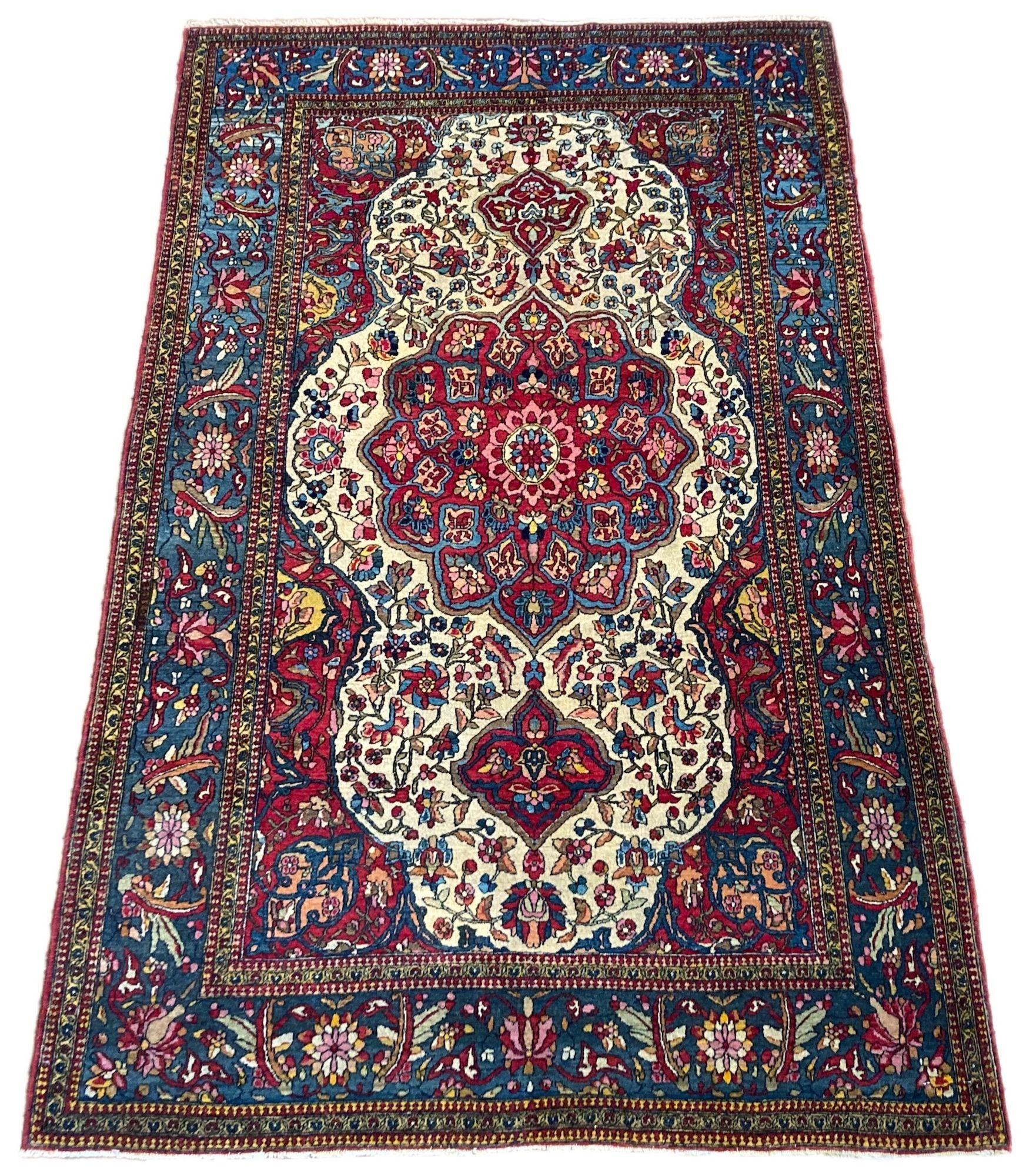 An outstanding antique Isfahan rug, handwoven circa 1900 with a classical floral medallion on an ivory field and indigo border. Finely woven with great wool and fabulous secondary colours, particularly the pinks and golds in the field.
Size: 2.02m