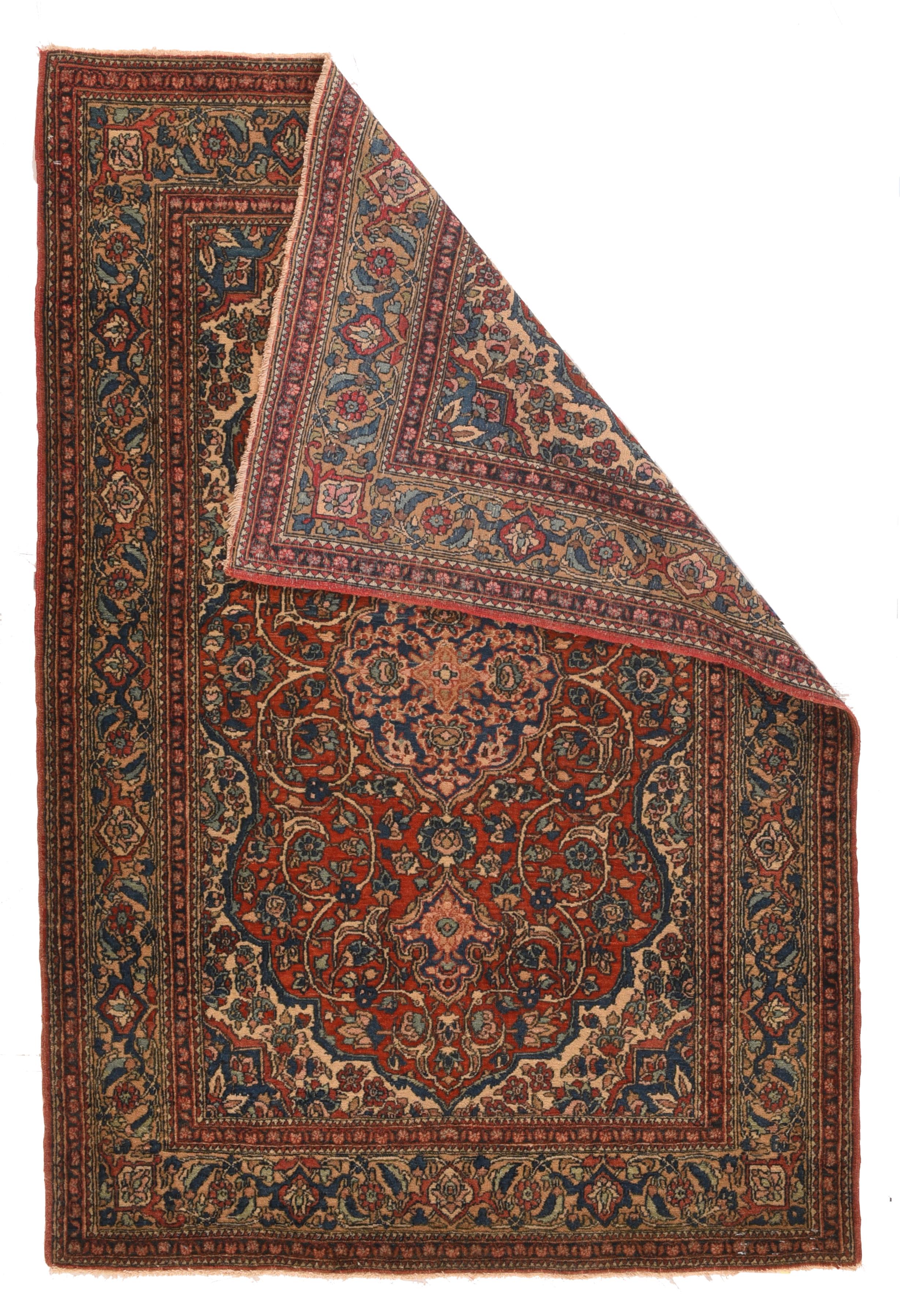 Looks like a Kashan, but actually it is a well-woven product of the Central Persian Chahar Mahal village complex. It certainly copies urban works, with its rust- red field, and volute, split ecru barbed arabesques, and gently scalloped ogival navy