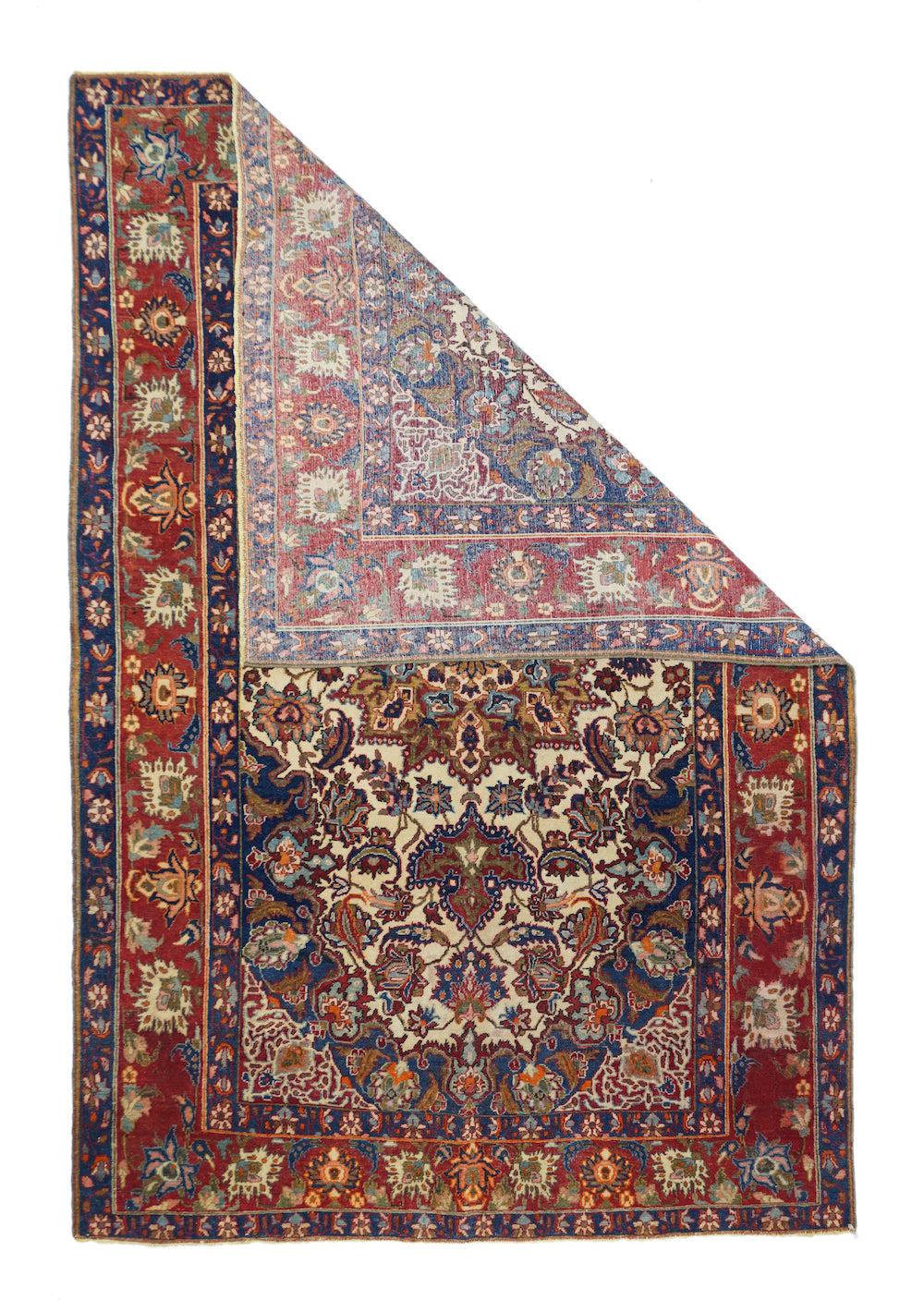 Antique Isfahan Rug 4'9'' x 7'5''. The sandy ivory field is decorated with large petal palmettes symmetrically flowing around the 16 point rounded medallion. Both medallion and escutcheon pendants are pearl edged. Navy corners with ecru arabesque
