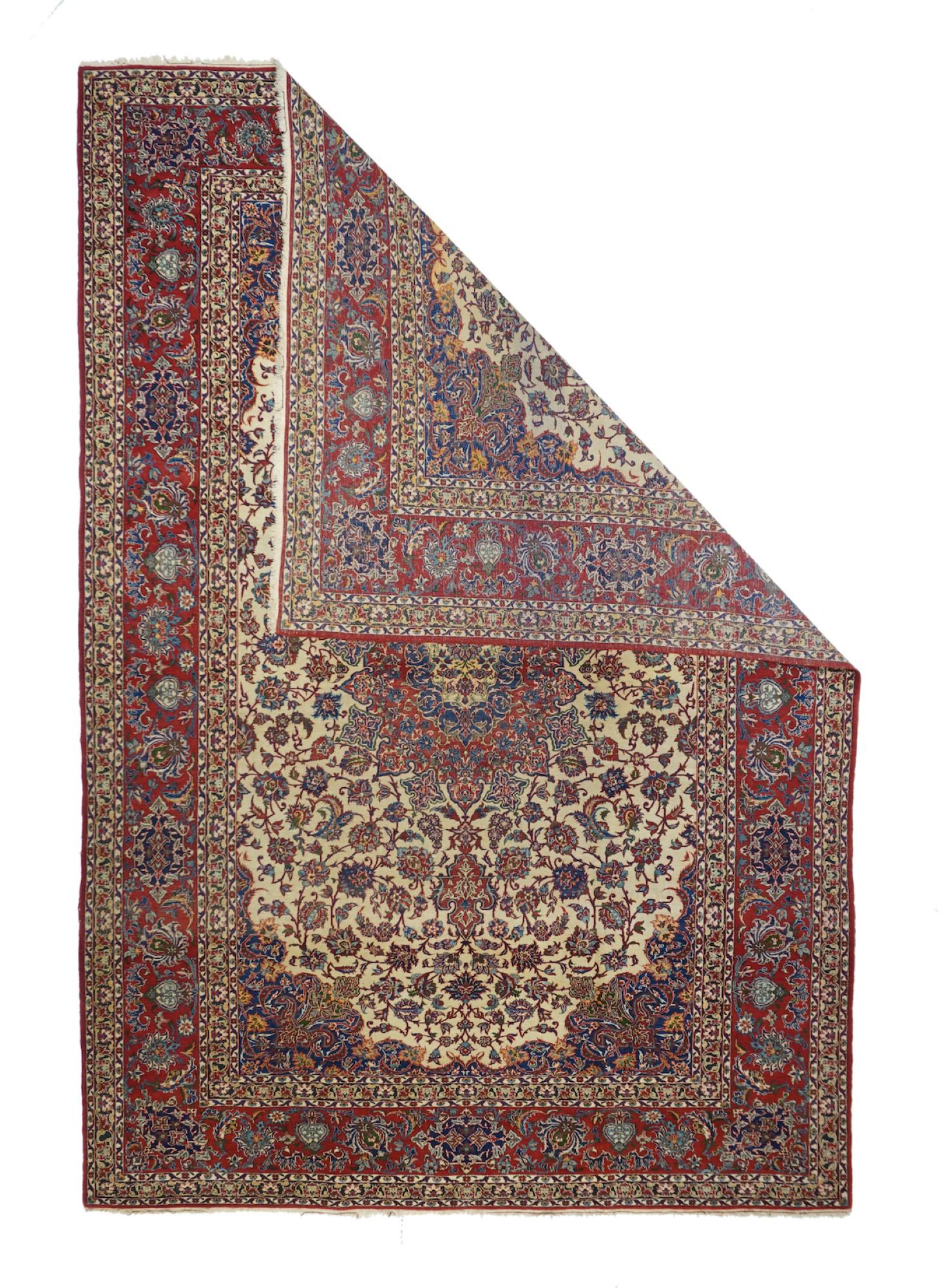 Antique Isfahan Rug 7'3'' x 10'6''. An upright, elliptical 20-point red arabesque medallion employs a straw and navy layered sub-medallion, on the old ivory ground whose complex palmettes diminish toward the implicit oval field ends; a