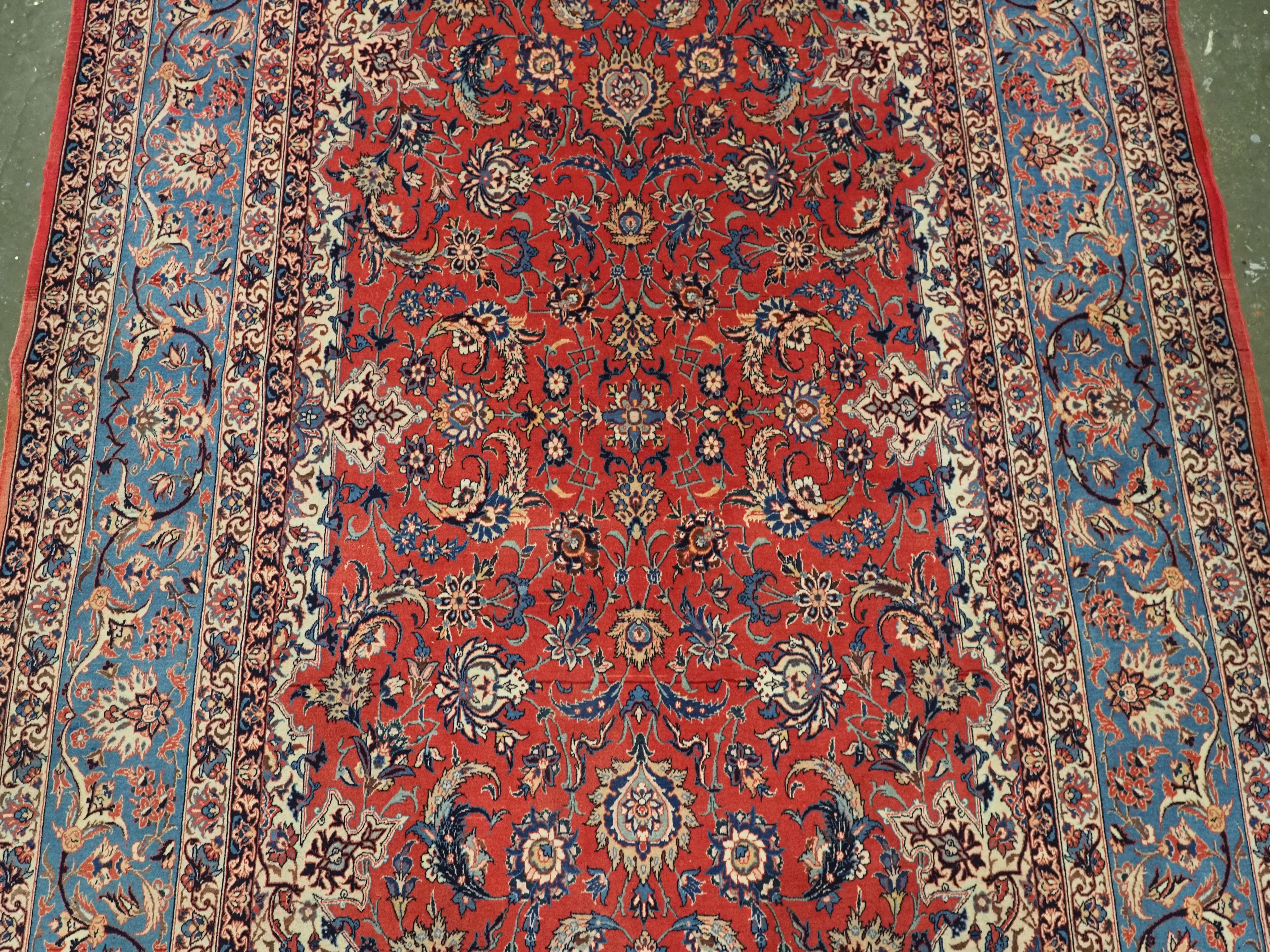 Antique Isfahan rug with all over design on warm red ground, circa 1920. In Good Condition For Sale In Moreton-In-Marsh, GB