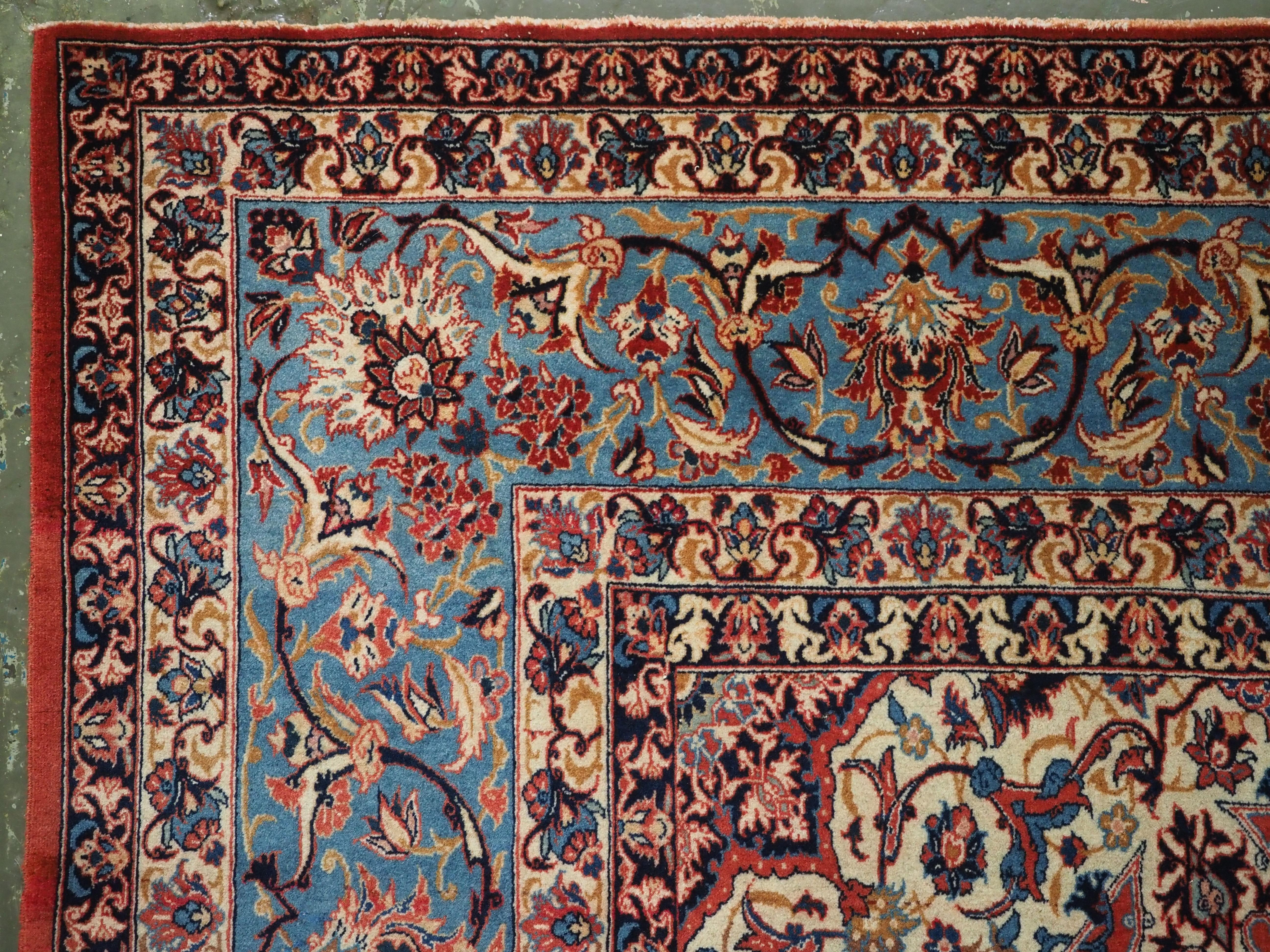 Wool Antique Isfahan rug with all over design on warm red ground, circa 1920. For Sale