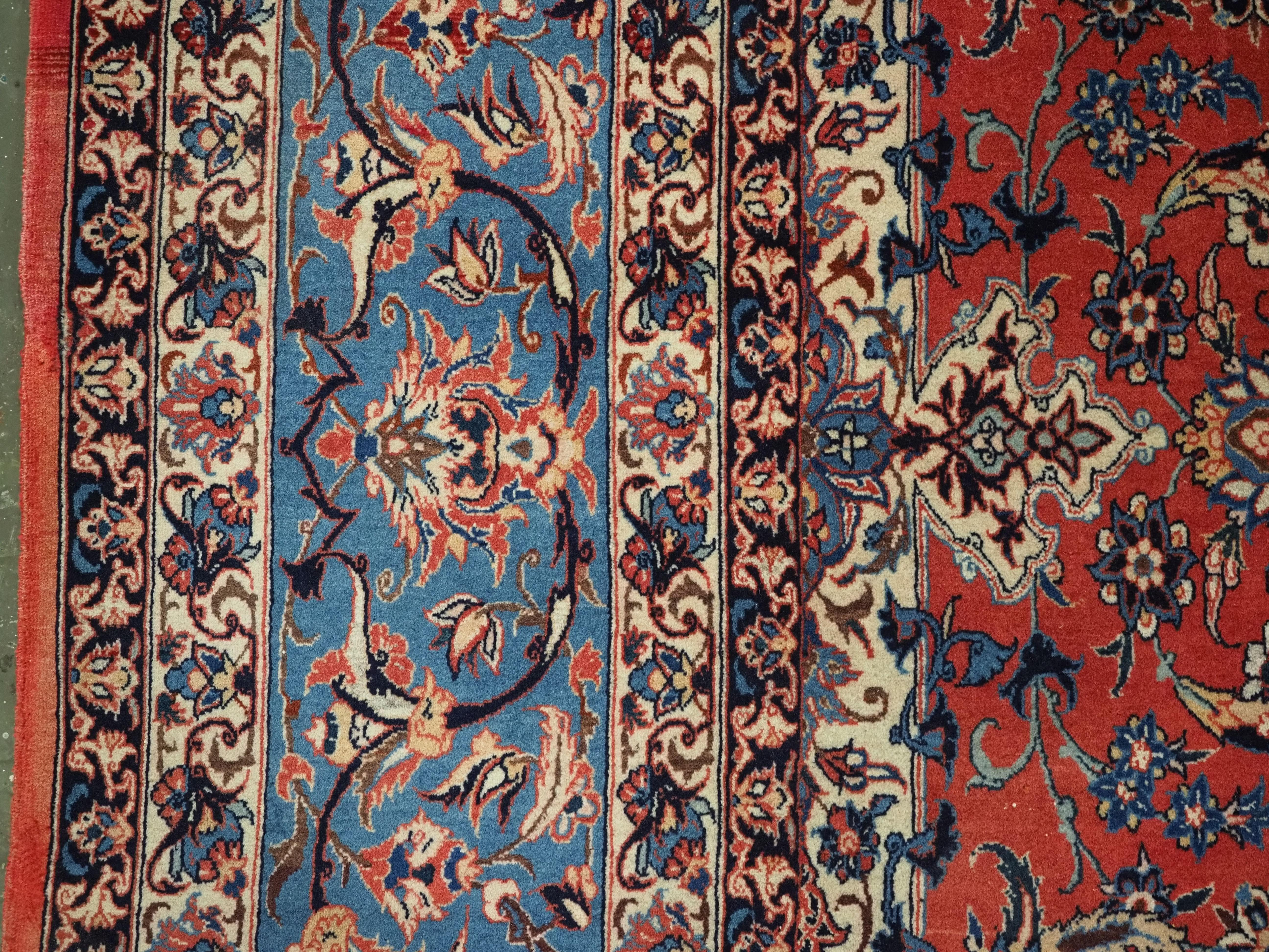 Antique Isfahan rug with all over design on warm red ground, circa 1920. For Sale 1