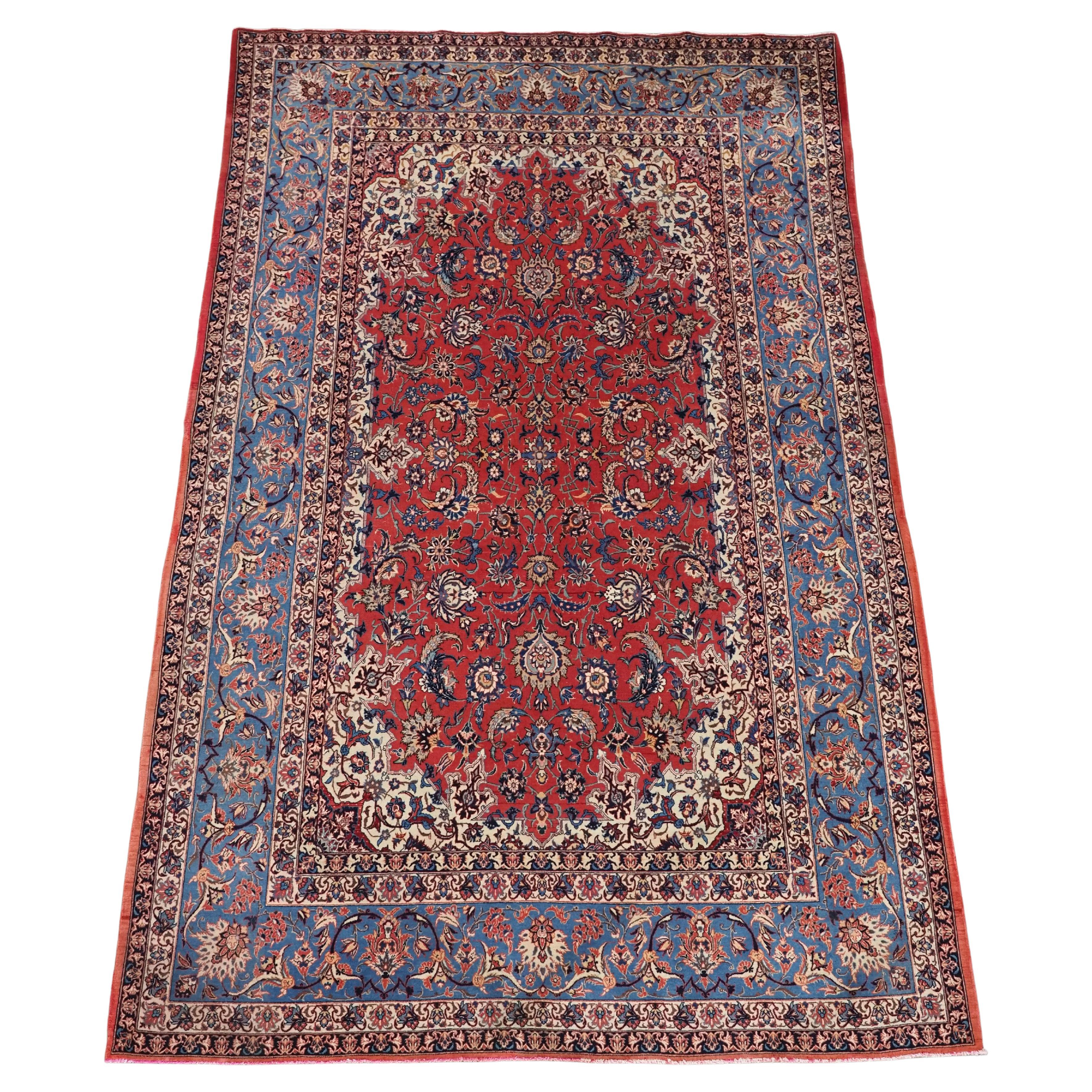 Antique Isfahan rug with all over design on warm red ground, circa 1920. For Sale