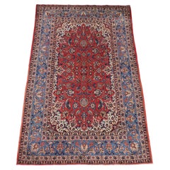 Antique Isfahan rug with all over design on warm red ground, circa 1920.