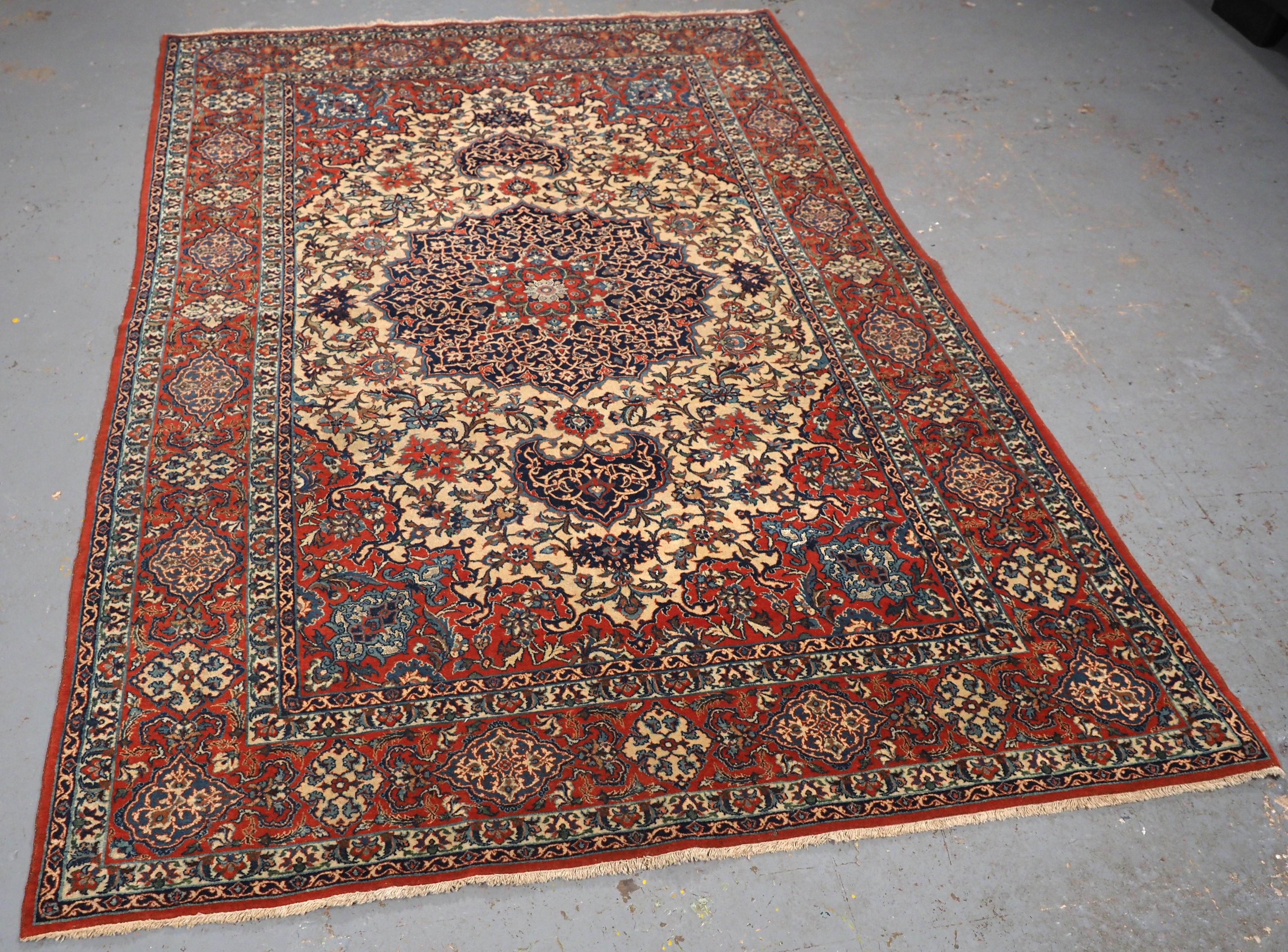 Size: 6ft 11in x 4ft 9in (210 x 145cm).

Antique Isfahan rug with small medallion design on an ivory ground.

Circa 1920.

The rug is of a fine weave with lambs wool pile on a fine cotton foundation, the rug has a floral design to the field, the rug
