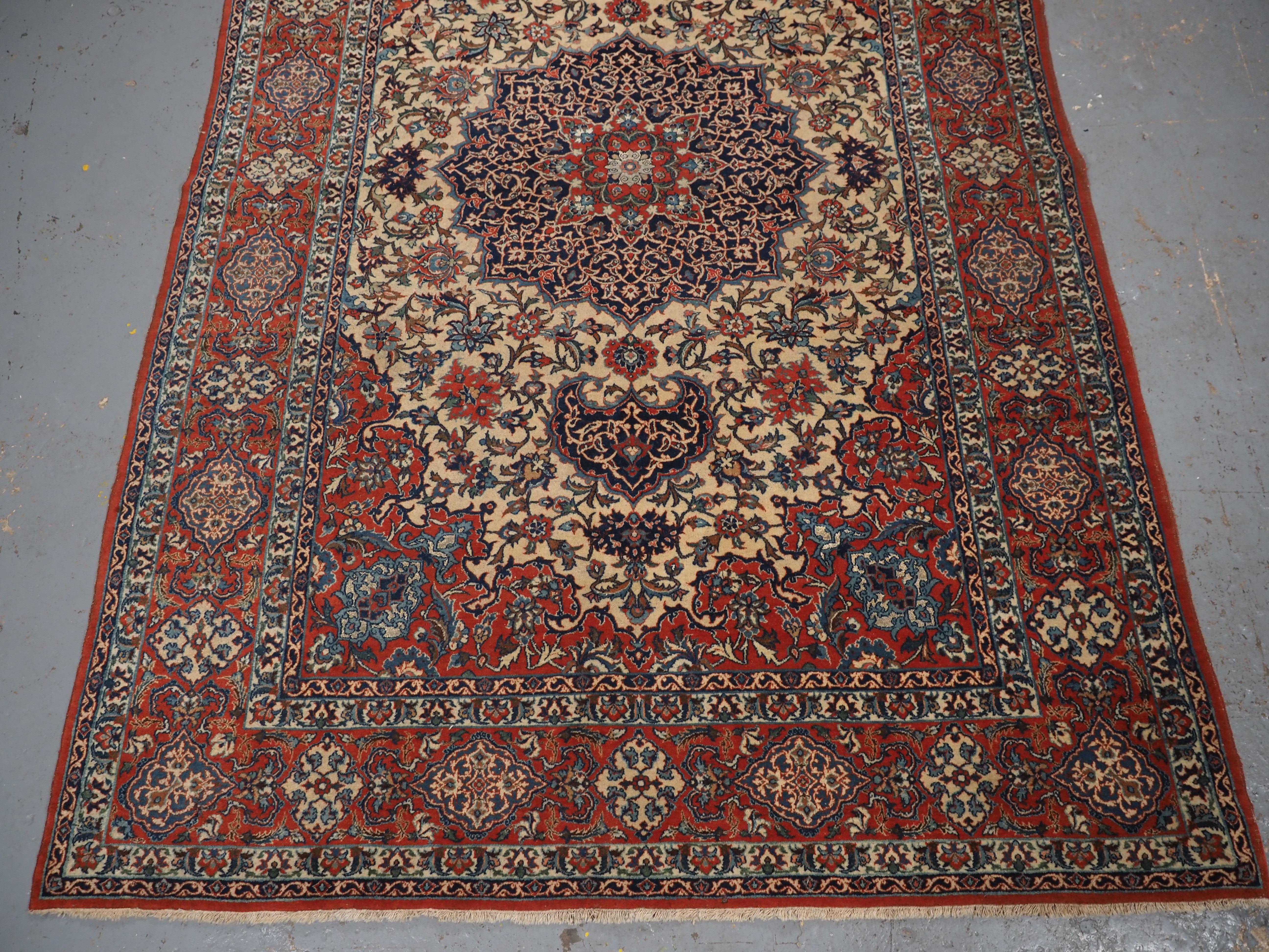 Early 20th Century Antique Isfahan rug with small medallion design on an ivory ground.  Circa 1920. For Sale