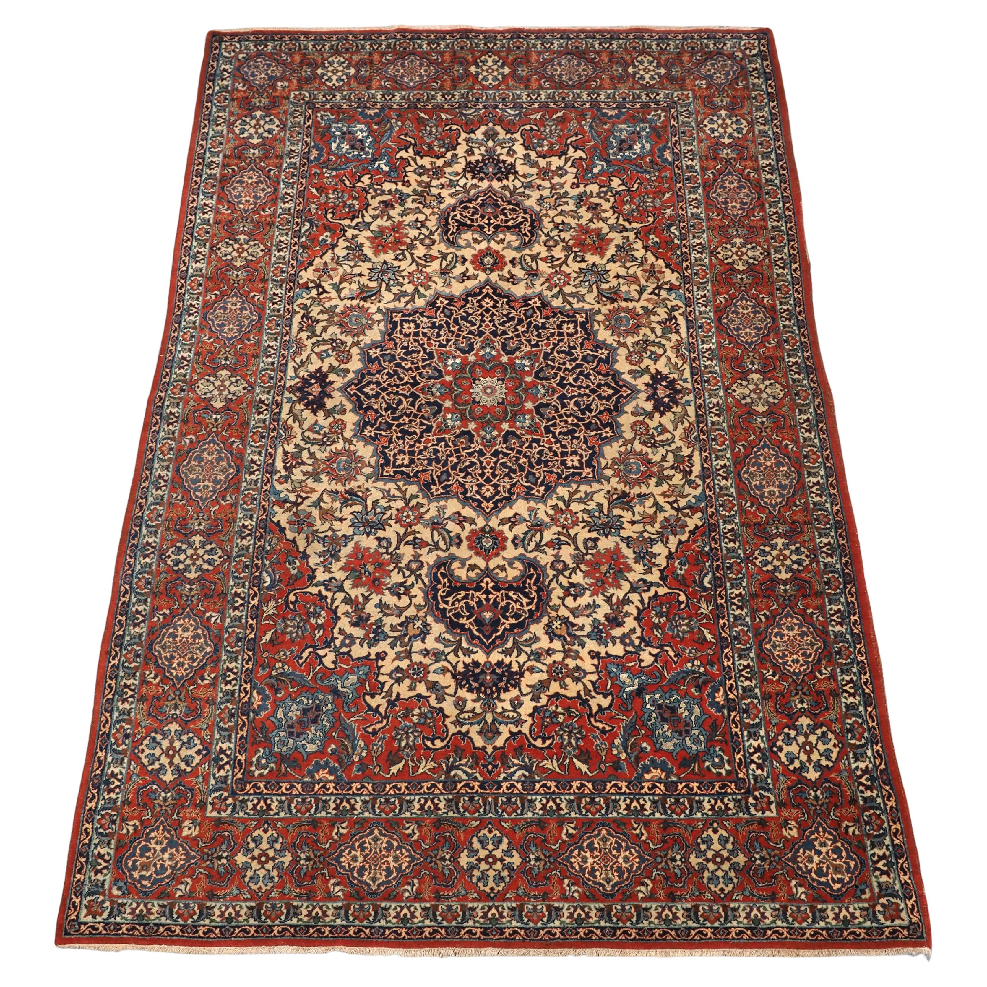 Antique Isfahan rug with small medallion design on an ivory ground.  Circa 1920. For Sale