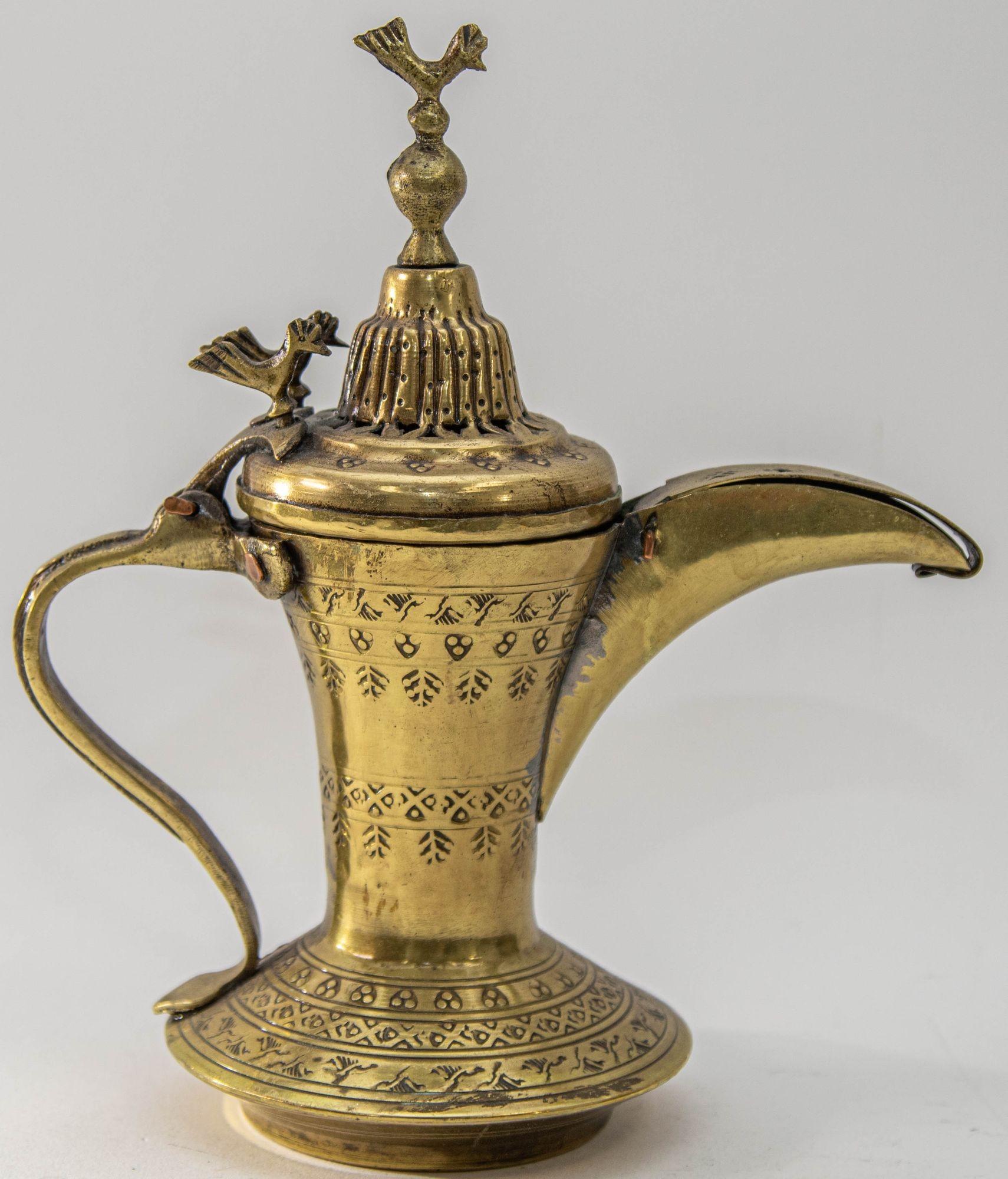 Antique Islamic Dallah Arabic Turkish Brass Coffee Pot or Tea Pot.
Middle Eastern Dallah Arabic brass coffee pot with birds and geometric etched tribal decorations.
Design features a beautiful engraved Nomadic motifs on the lid and on the body of