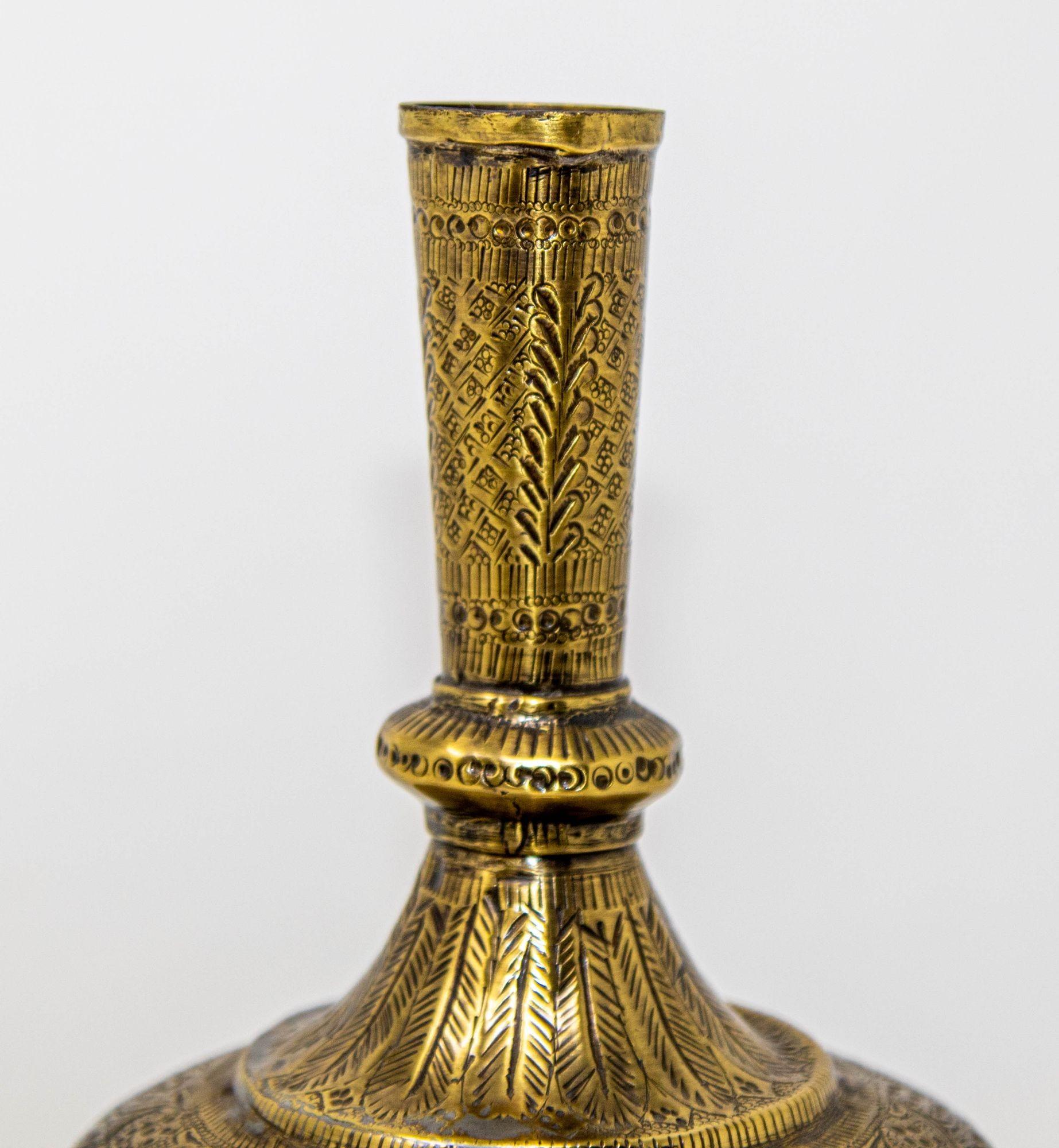 Antico vaso persiano in ottone inciso.
Vaso persiano in ottone inciso con fogliame e uccelli dai dettagli intricati.
Il vaso è stato sapientemente inciso a mano e mostra raffigurazioni di figure danzanti circondate da un motivo fogliare altamente