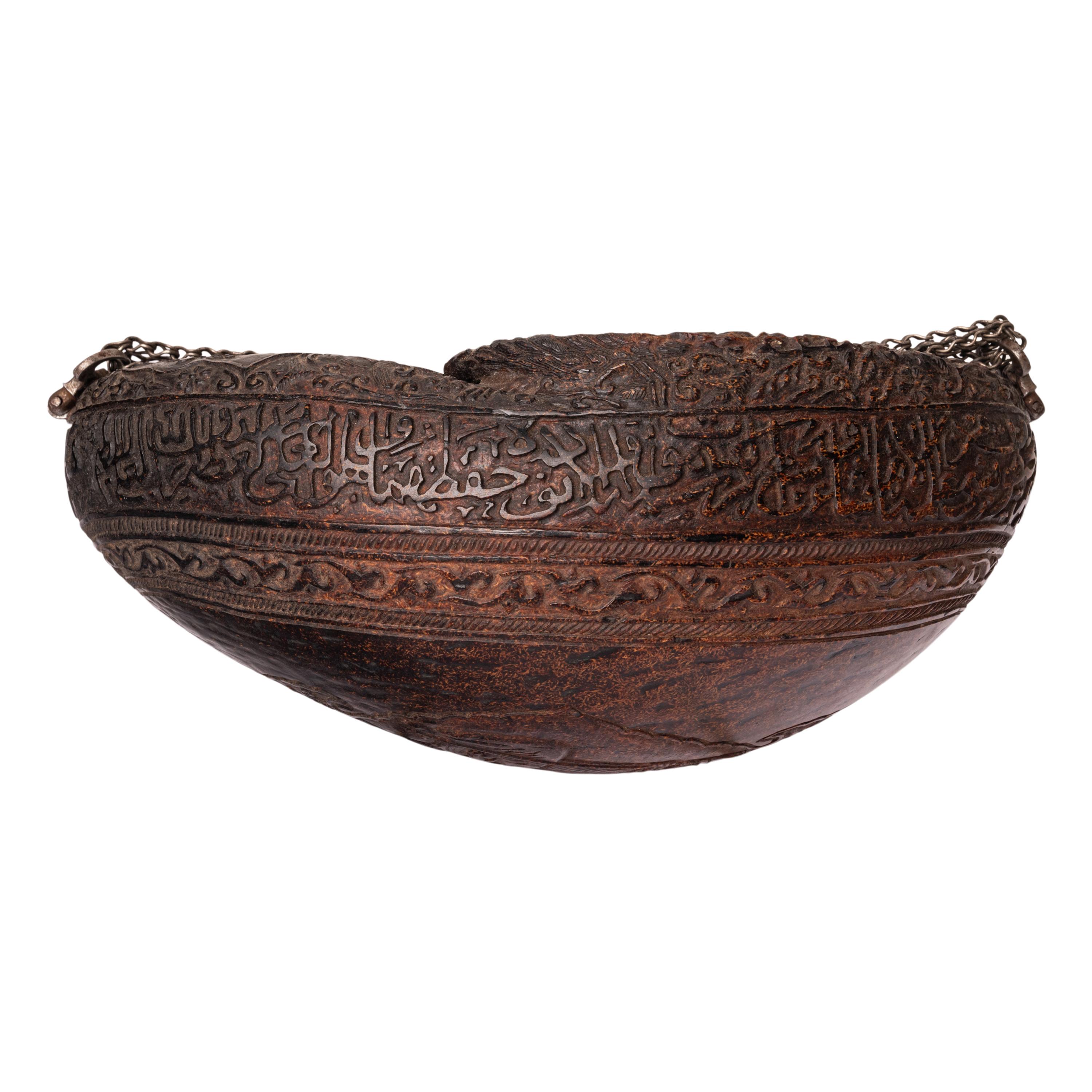 Rare antique Persian Islamic carved Kashkul (Sufi begging bowl) coco-de-mer, Safavid period, Persia, circa 1740.
This fine & rare kashkul is carved from the fruit of the palm tree 