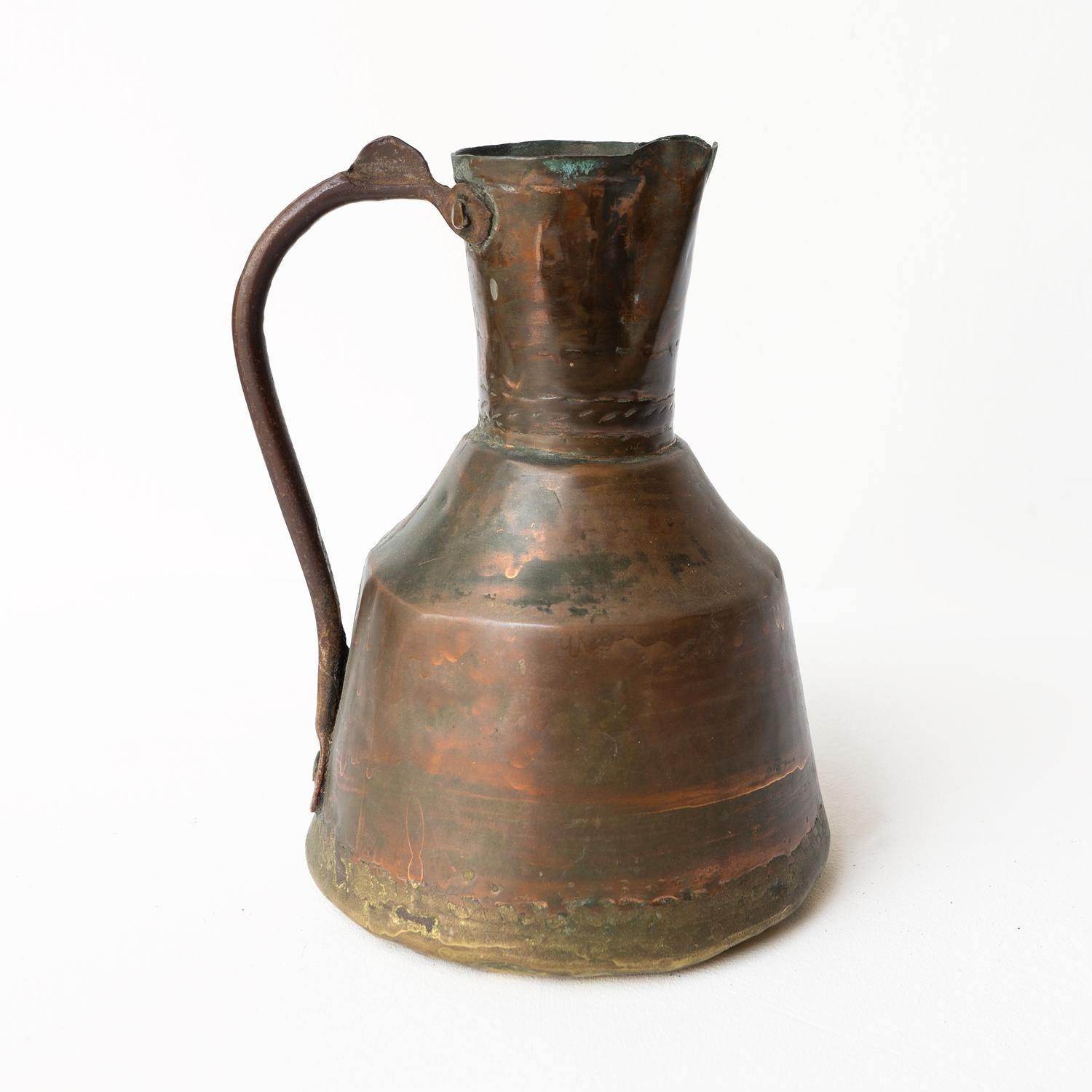 PRIMITIVE ANTIQUE JUG/EWER

Handmade from a number of metals with a hand-hammered copper main body dovetailed with a brass base and wrought iron handle.

A hugely decorative piece with great presence and form.

Probably dates from the early 19th
