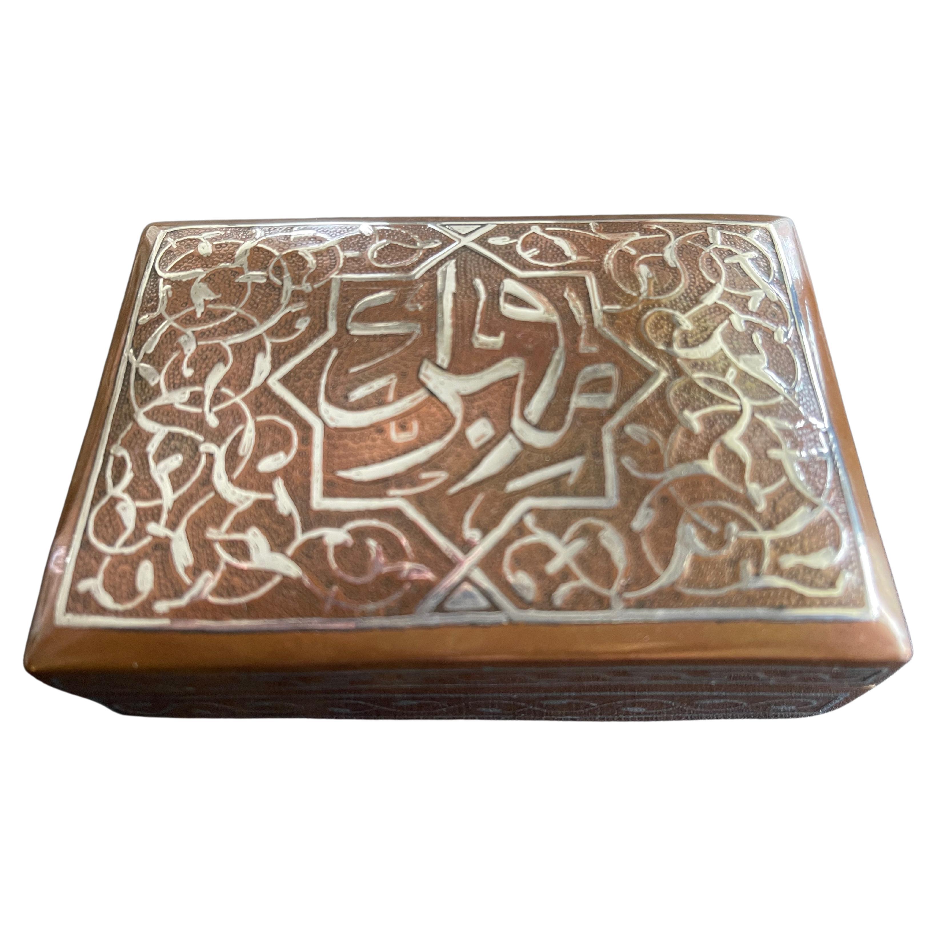 Antique Islamic silver calligraphy damascened copper jewelry box with hinged lid. Copper is finely hand hammered into a wonderful texture. Interior fully lined in cedar wood. Egypt, c. 1920's.

 