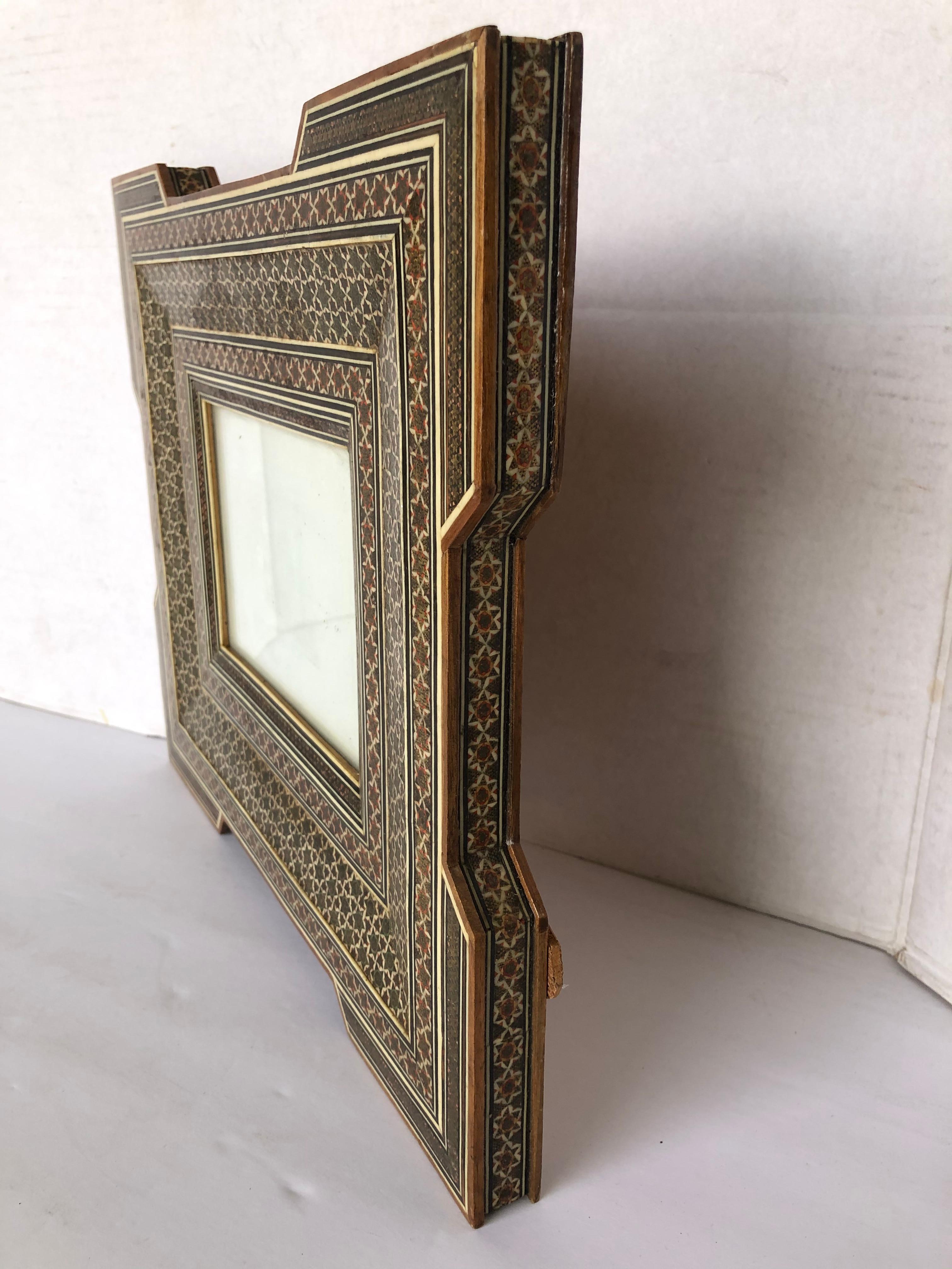 Antique Islamic woodwork picture frame possibly from the Middle East. This is a typical form of Islamic Art.
It is a museum-quality piece. This pretty antique picture frame is decorated with a repeated form of plants motifs and geometric shapes. In