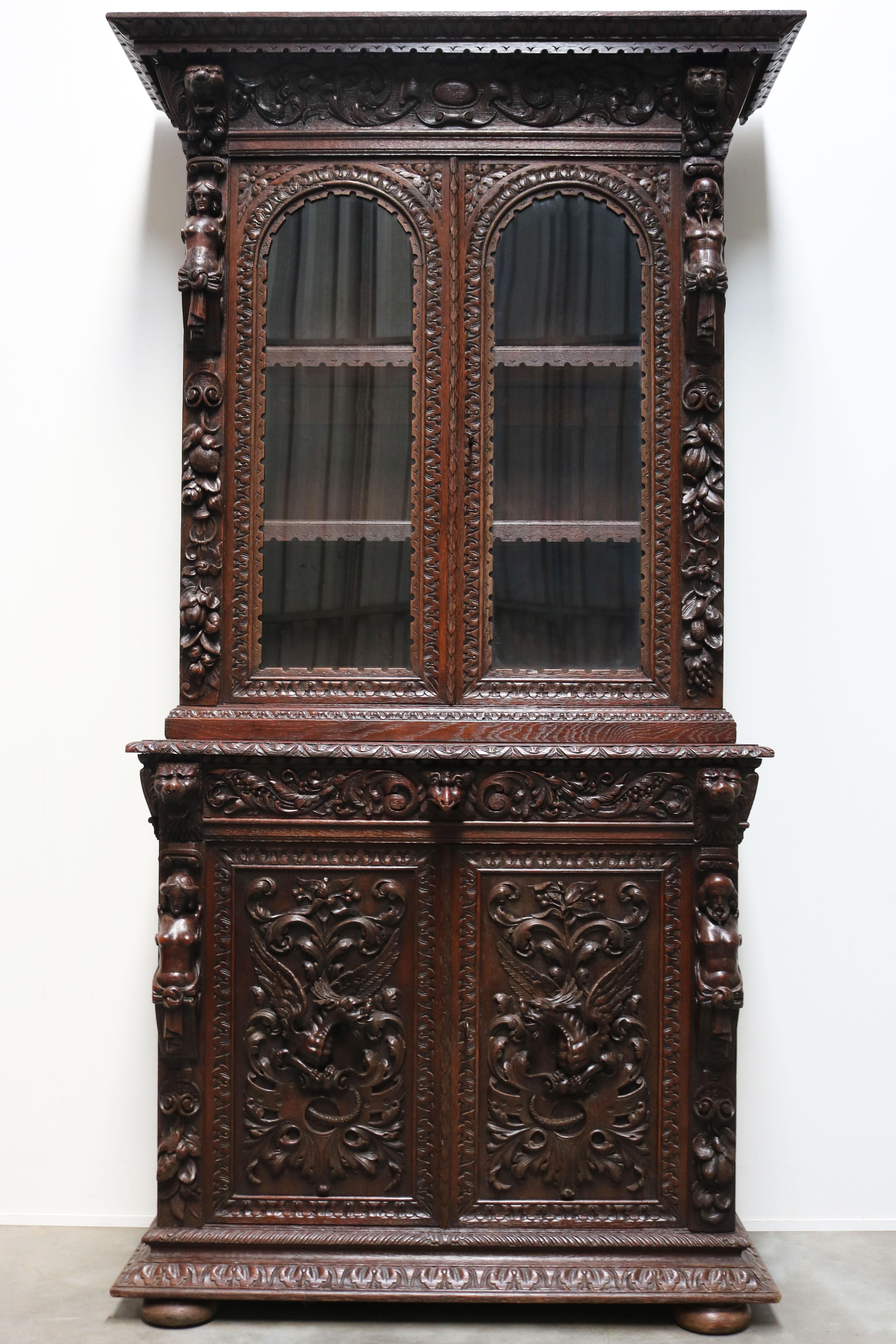 Exquisite & stunning! This rare 19th century Italian Renaissance Revival cabinet / bookcase / buffet in carved oak. 
The craftsmanship of the lion heads, angels & dragons is simply marvelous. Hand carved from oak and free carved out of the cabinet