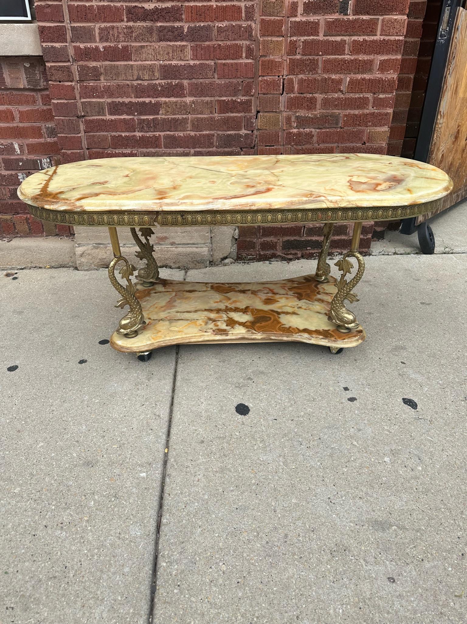 Antique Italian 2 Tier Ornate Onyx and Figural Koi Fish Sculpted Brass Framed Coffee Table

Beautiful Beveled Edge Oval Amber Veined Green Onyx with Intricate Detailed Sculpted Ornate Brass Frame with 4 Japanese Fighting Koi Fish flanking each