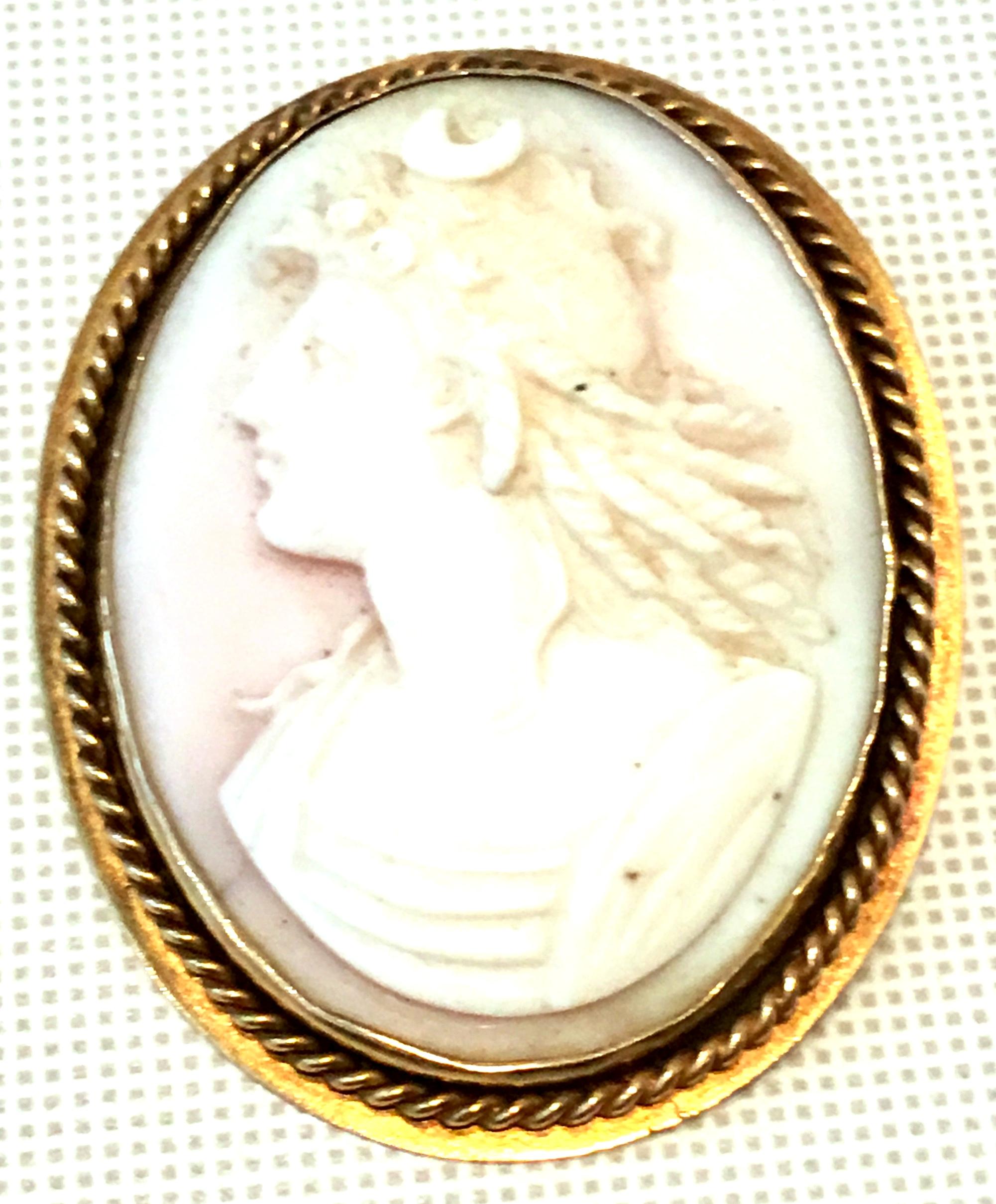 Antique Italian 9K Gold & Highly Carved Pink Shell Cameo Brooch. Features a finely crafted left facing female with a moon form detail in her long cascading hair.
Total weight, 14 grams.