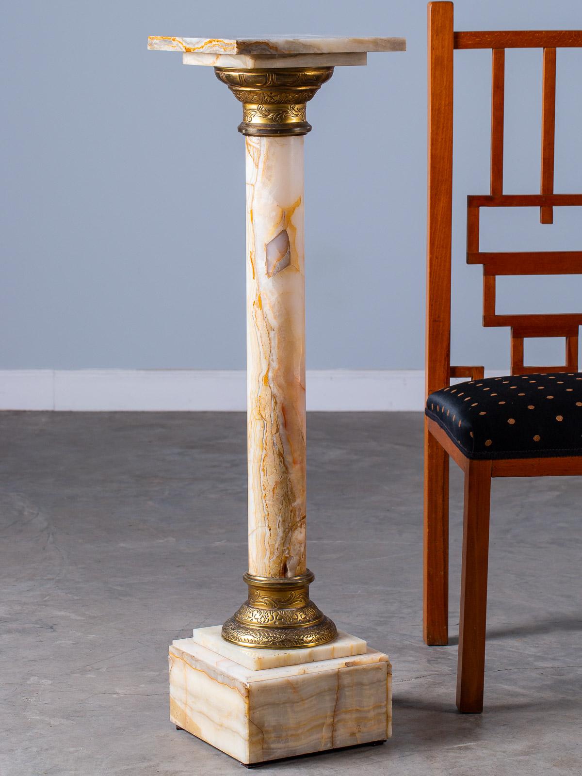 Antique Italian alabaster column pedestal with etched gilt bronze collars, circa 1890. This Classical style pedestal column is taken from examples seen in the ancient civilizations of Greece and Rome. Having a removable display top the slender