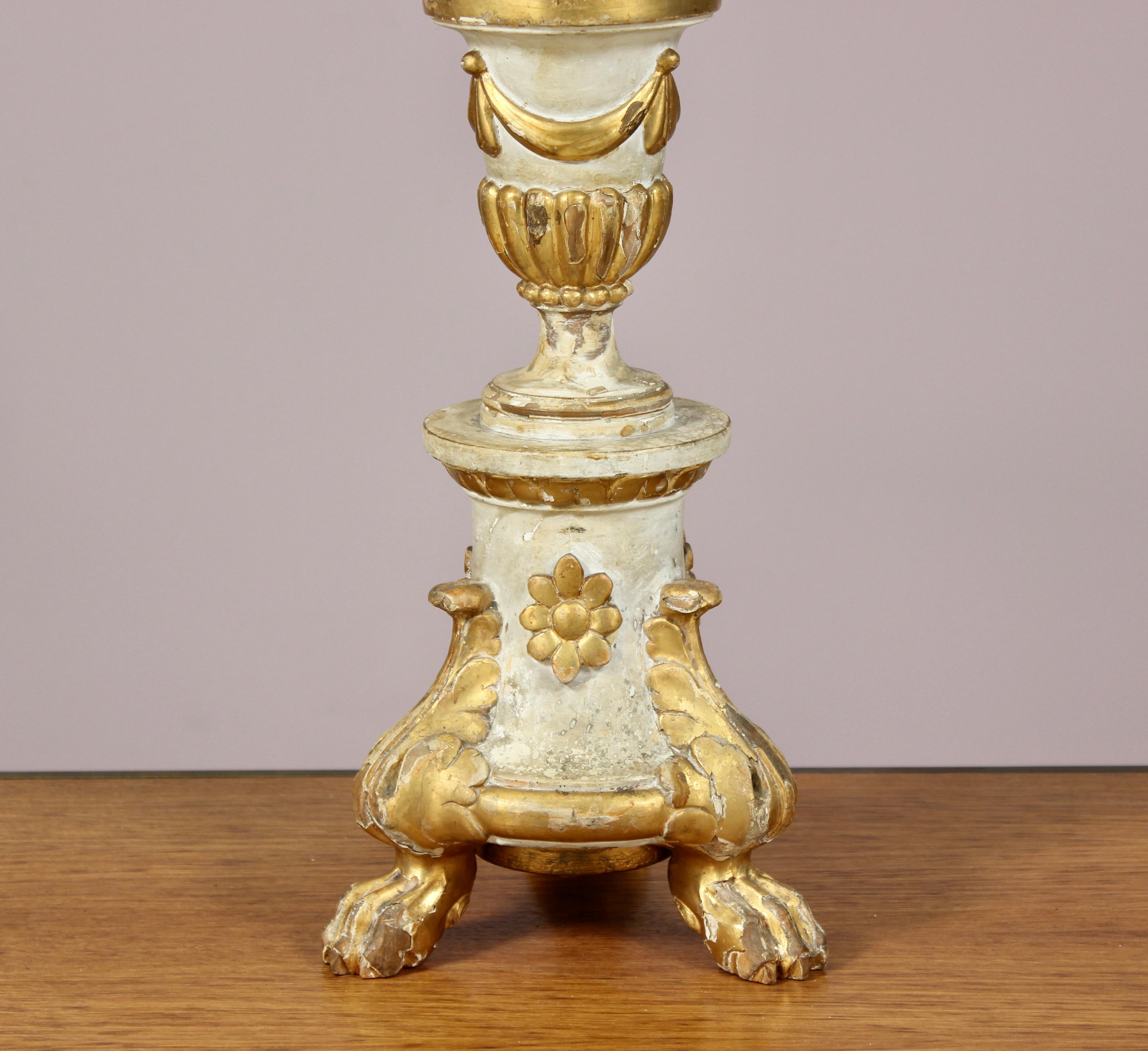 19th century Italian painted and parcel gilt wood altar stick lamp with beautifully carved details. Naturally distressed paint finish. Newly rewired. Lampshade is for display only. Altar stick height 29”.