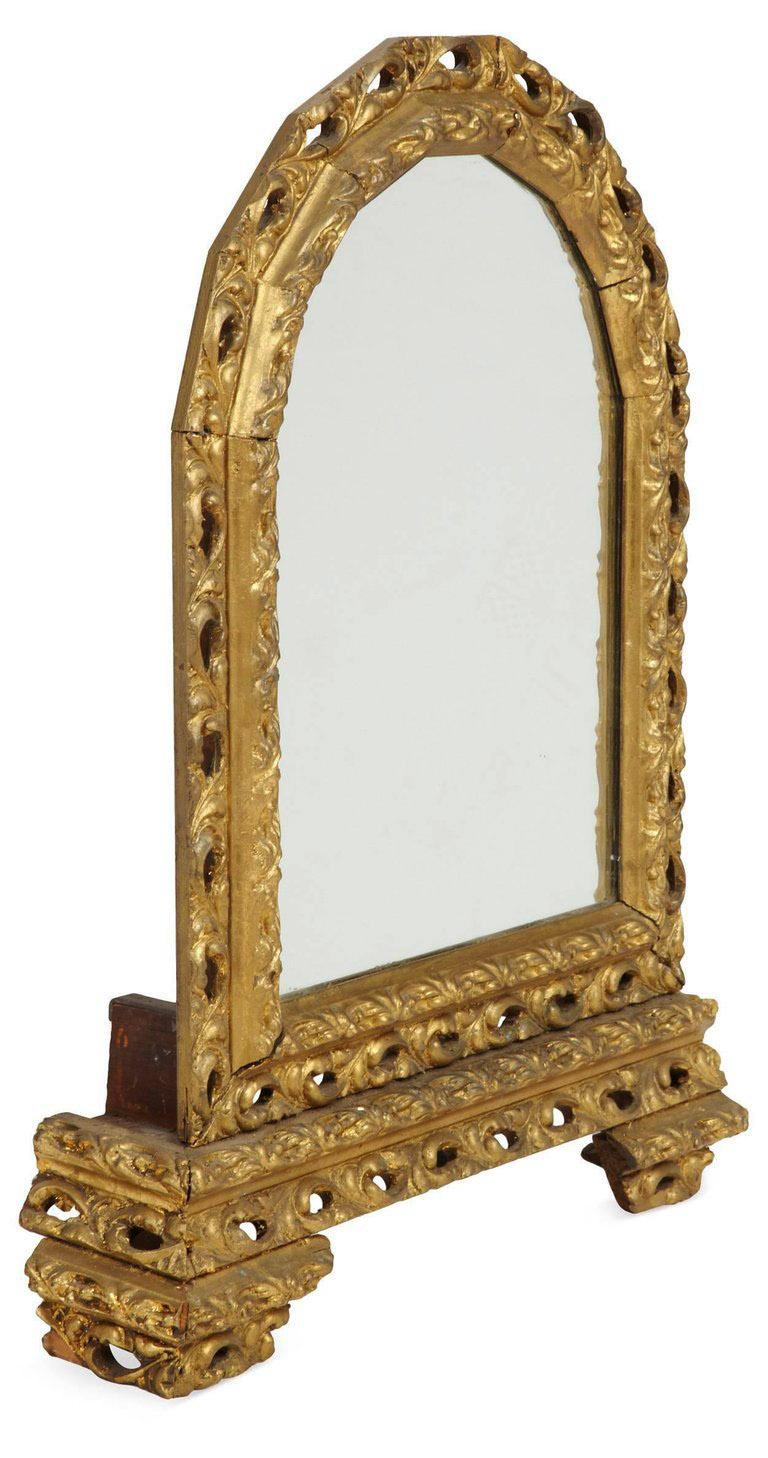 Antique Italian baroque arched giltwood standing mirror with heavily carved gilt frame. Hang on a wall or sit on a table, a perfect mirror to add interest to any room. Great for a vanity table.