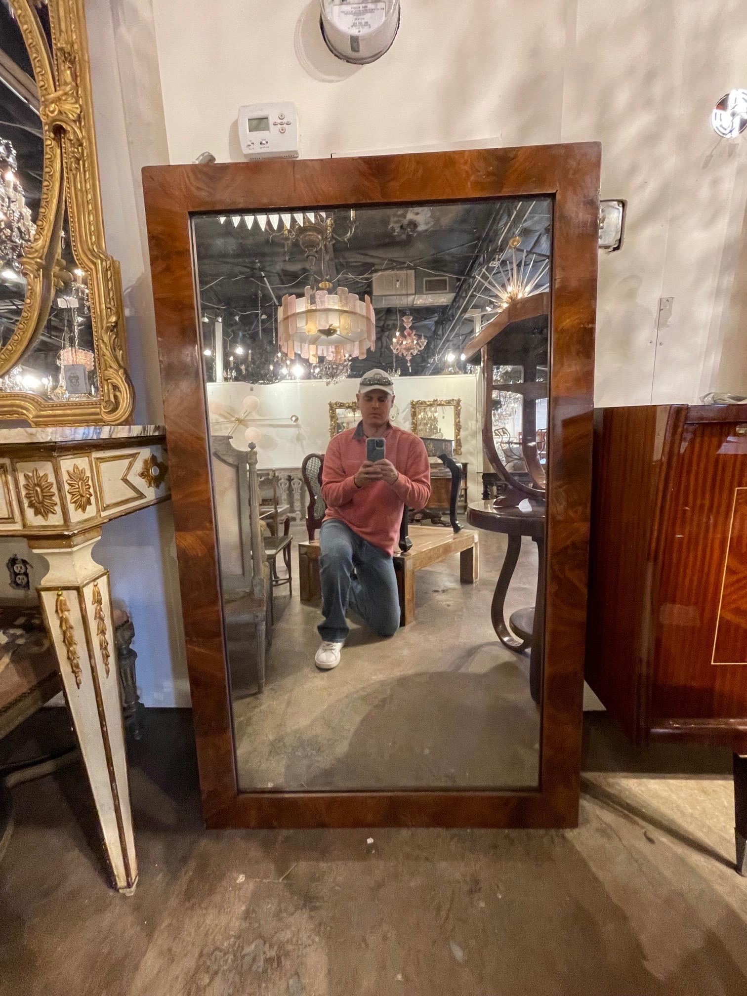 Handsome antique Italian Art Deco style walnut mirror. Beautiful wood grain on this piece. Creates an upscale polished look!