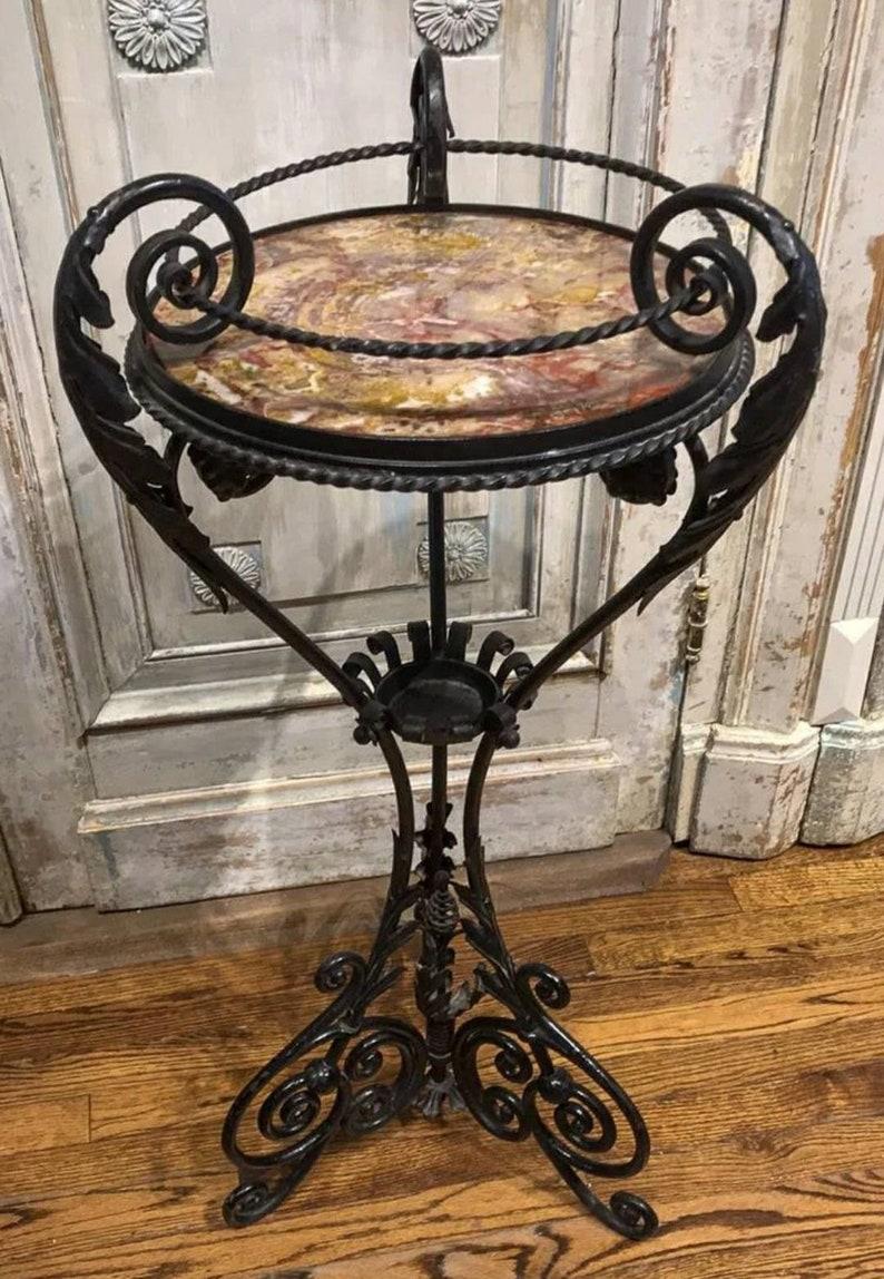A spectacular, highly artistic, superb quality, forged iron jardinière planter / pedestal table attributed to celebrated master ironworker and decorator Alessandro Mazzucotelli (Italy, b.1865-d.1938)

Featuring the distinctive spring-loaded