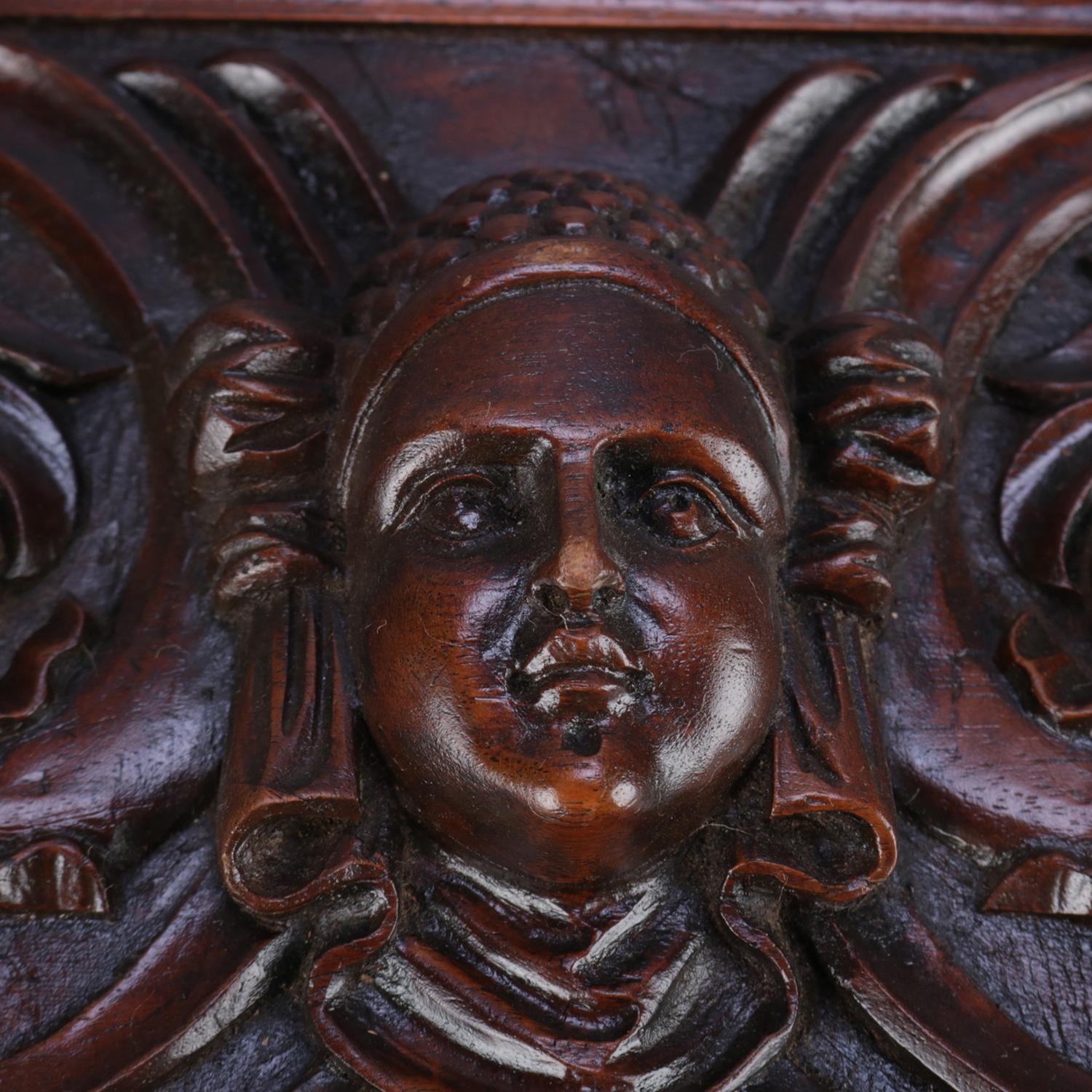 An antique Italian Baroque architectural panel features carved cherry construction having high relief central cherub mask and flanking bird and scroll designs, circa 1890.

Measures: 10.25