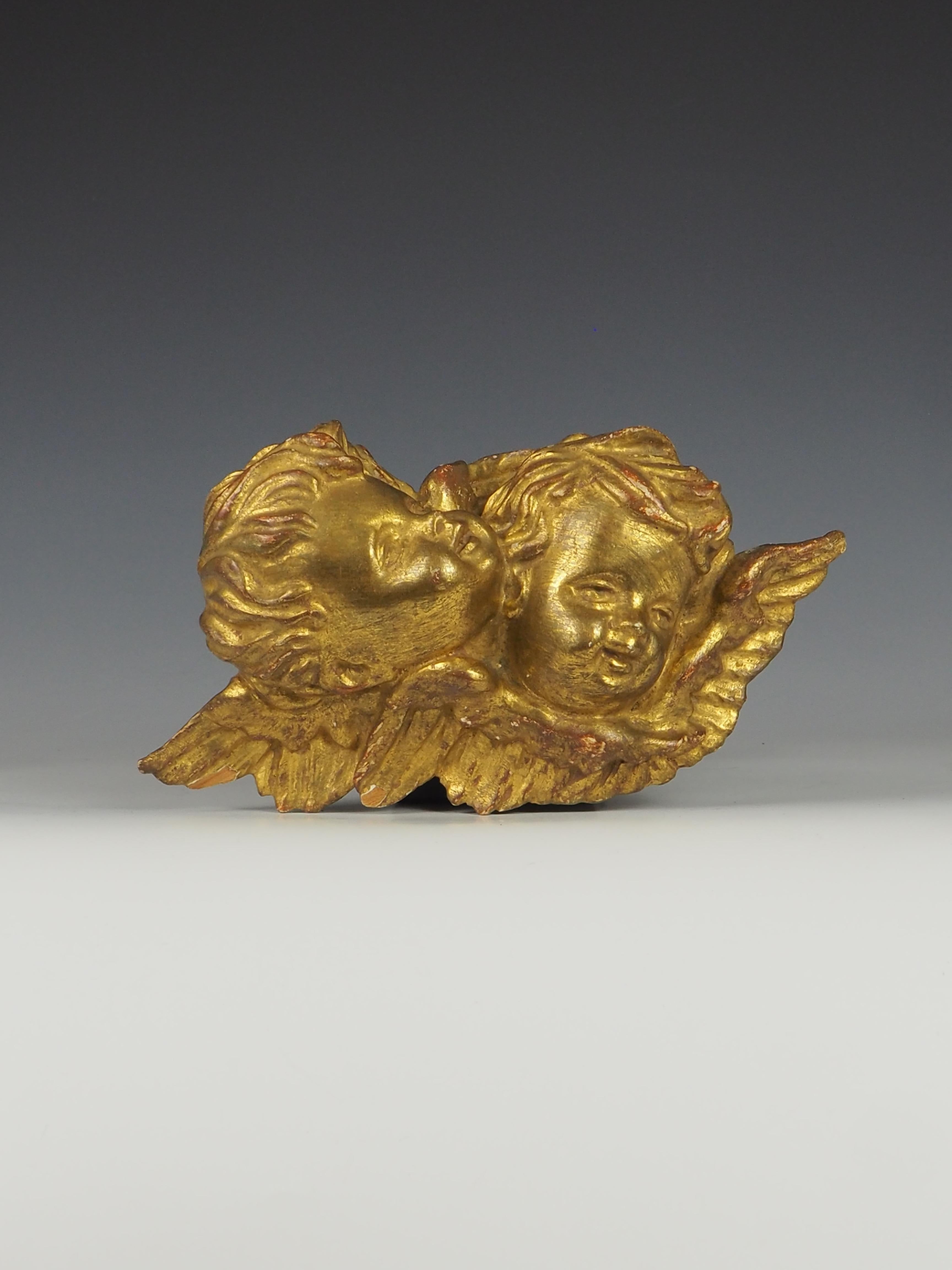 Exquisite 19th Century Antique Italian Baroque Carved Giltwood Twin Cherub/Putti wall hanging is a stunning example of masterful craftsmanship and artistic detail.

The cherub wall panel is expertly carved, showcasing a remarkable level of detail in