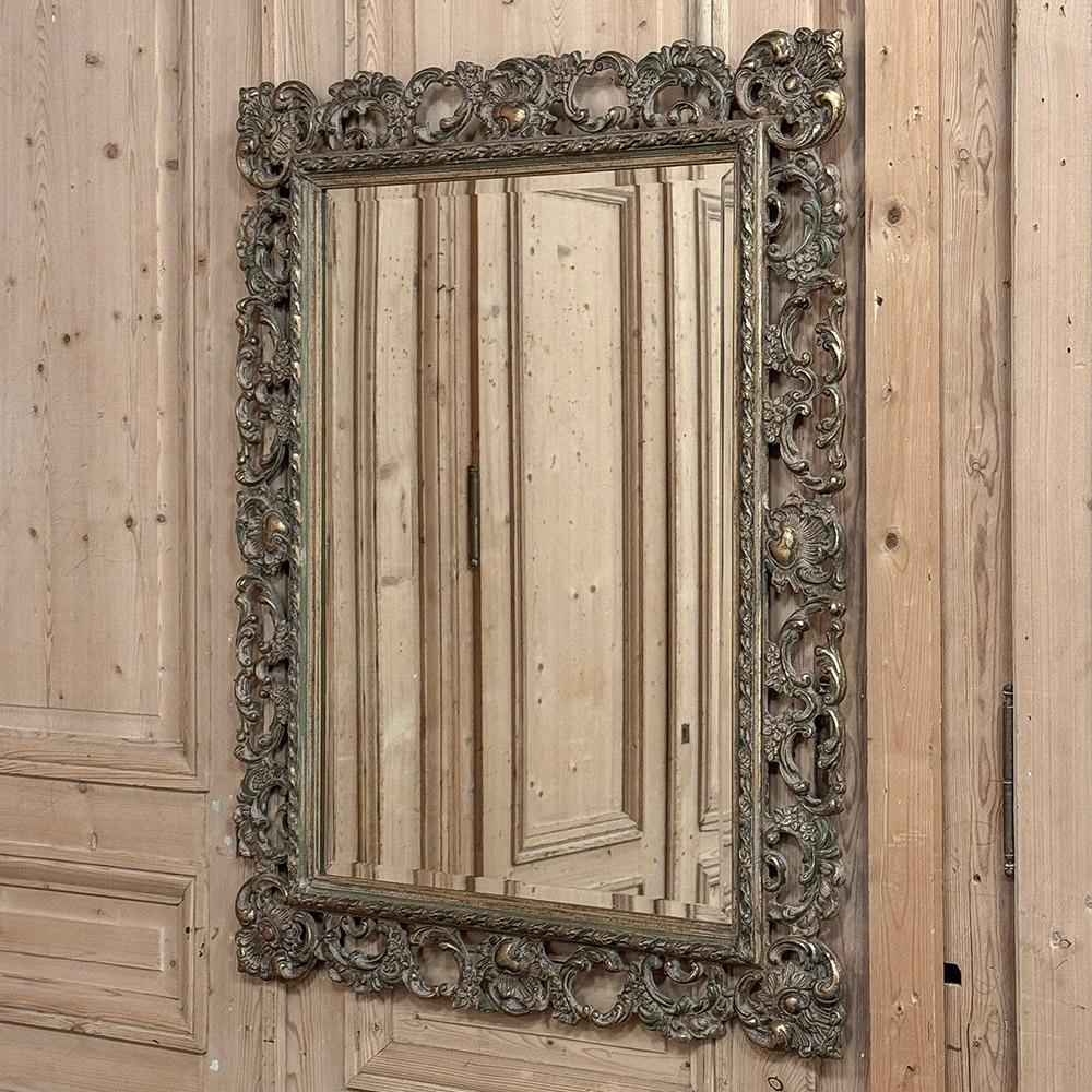 Antique Italian Baroque Carved Giltwood Wall Mirror is yet another example of the craftsmanship and artistry from the peninsula of Italy, renowned for millennia for such designs.  The entire frame is carved from solid wood, then given a silvered